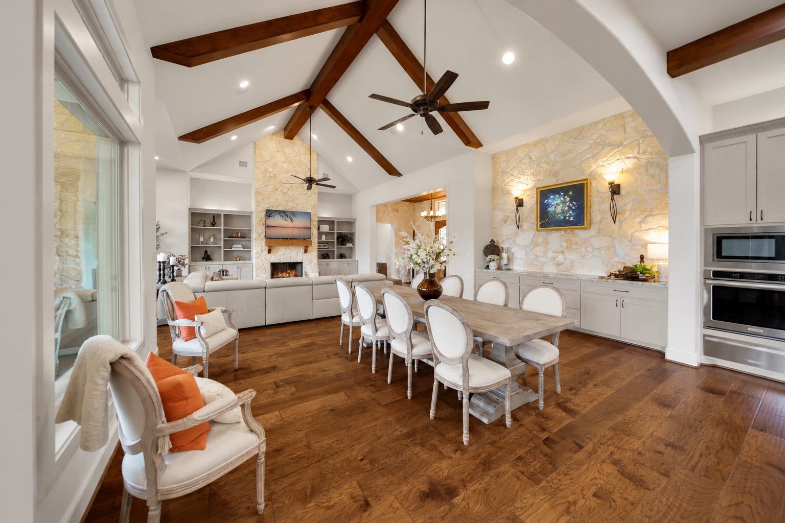 From the first course to the last cup of coffee, the kitchen stays close to the table. Beamed ceilings and wood floors carry the same warm character through both areas.