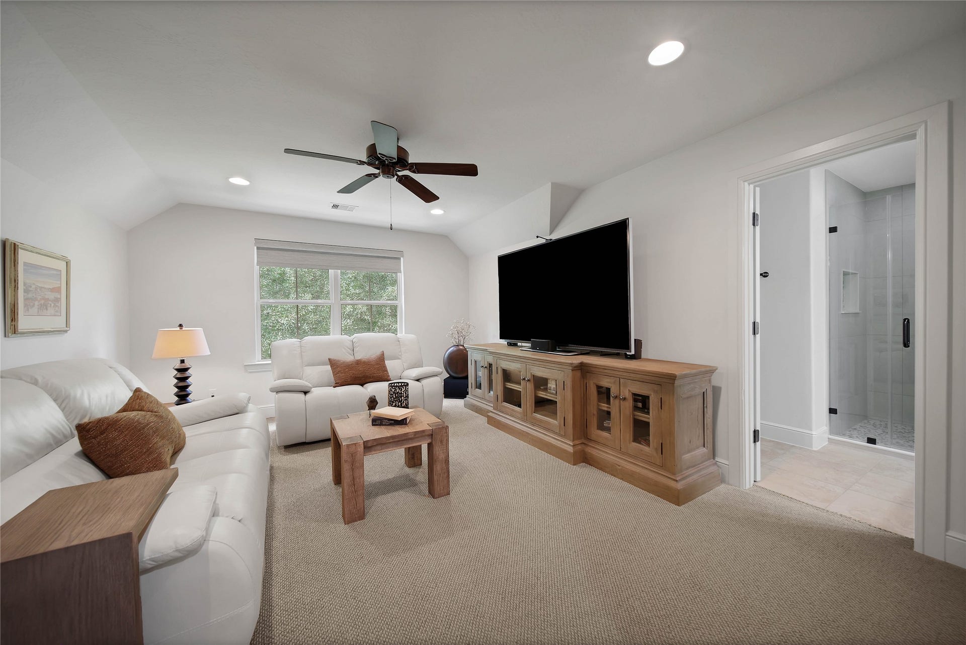 An upstairs room introduces a quieter chapter. Shown with a sofa and television, it offers inspiration for a separate retreat for reading, conversation or an evening movie. The full bath en'suite gives the room flexibility to be the fourth bedroom.