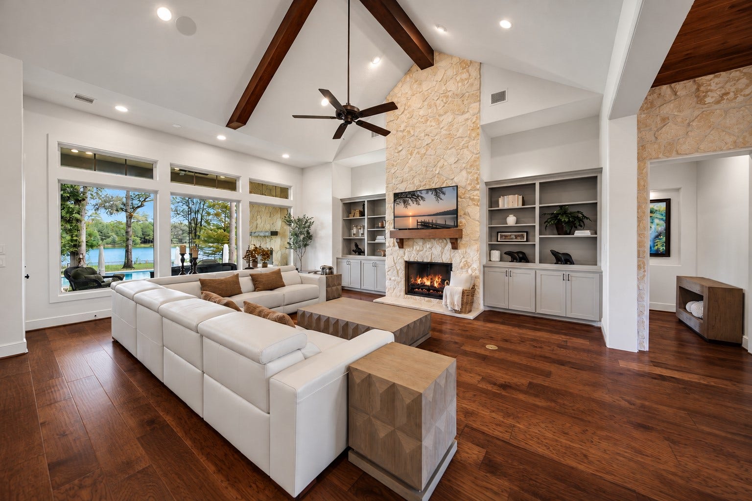 Settle beside the fireplace with the grounds still in view. Broad windows bring the outdoors into the room, making a quiet afternoon indoors feel connected to the lakefront setting.