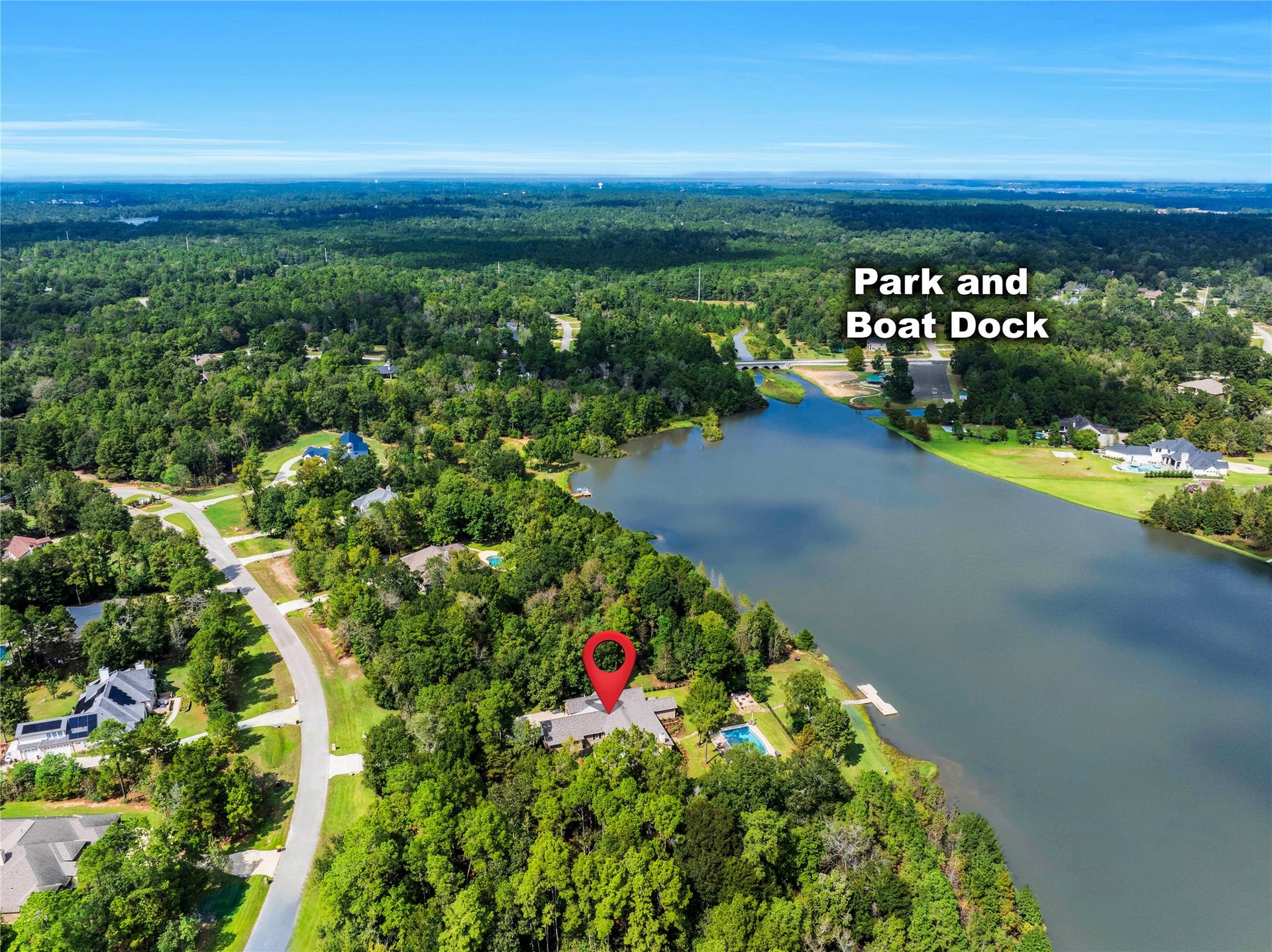 Another perspective shows a short boat ride to the neighborhood park beyond. The marker identifies the location; the wider landscape provides context for its waterfront setting.