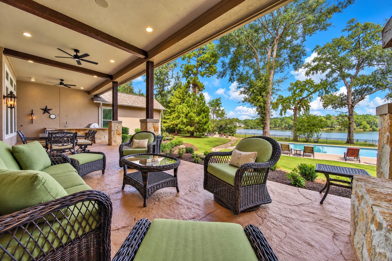 Start the morning here, coffee in hand and the lake beyond the trees. With overhead shelter and an outdoor fireplace, the patio invites another chapter of the day outside.