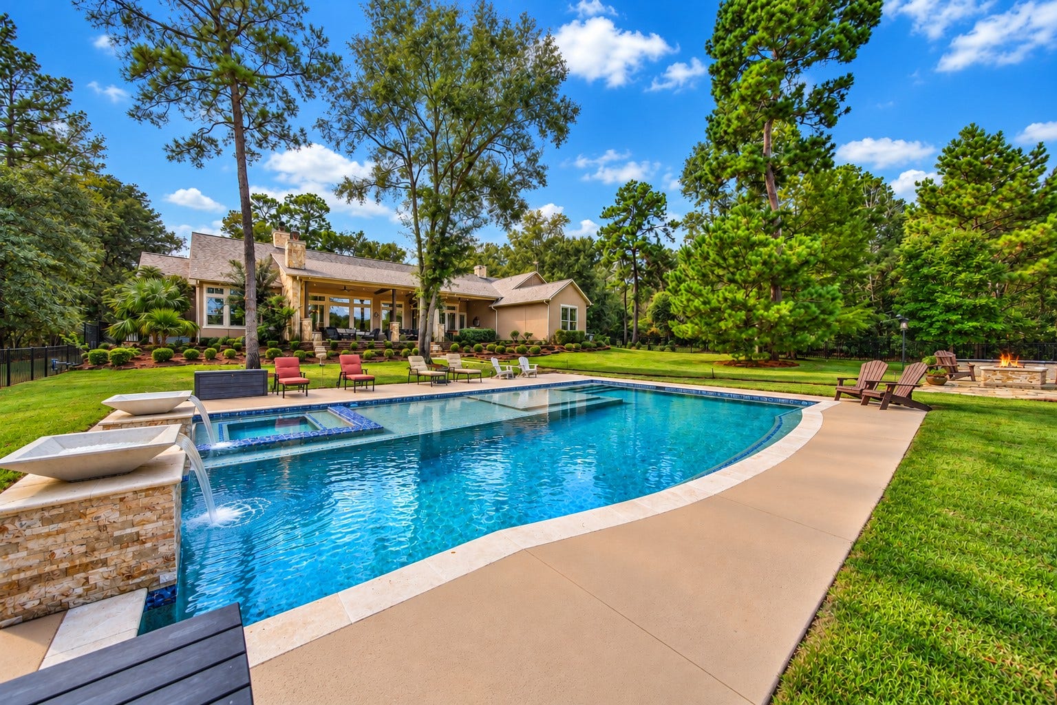 Looking back from the pool, the home and covered patio remain close at hand. A swim can become lunch on the terrace, followed by an afternoon with no reason to hurry.