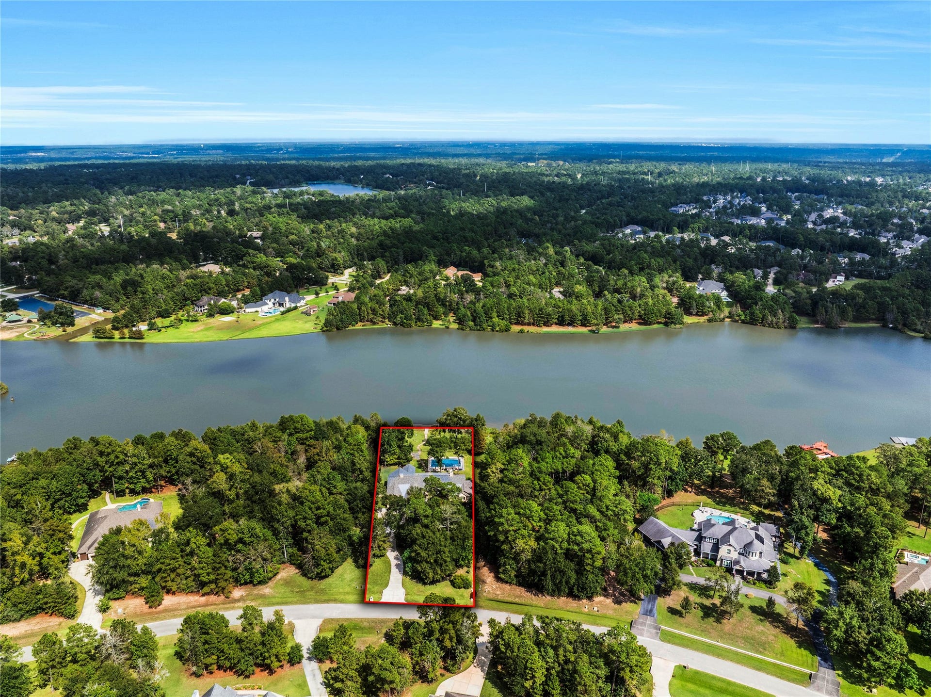 The story closes where it beganwith the lake. This final perspective brings the home, pool and grounds together in one view of the setting that shapes daily life here.