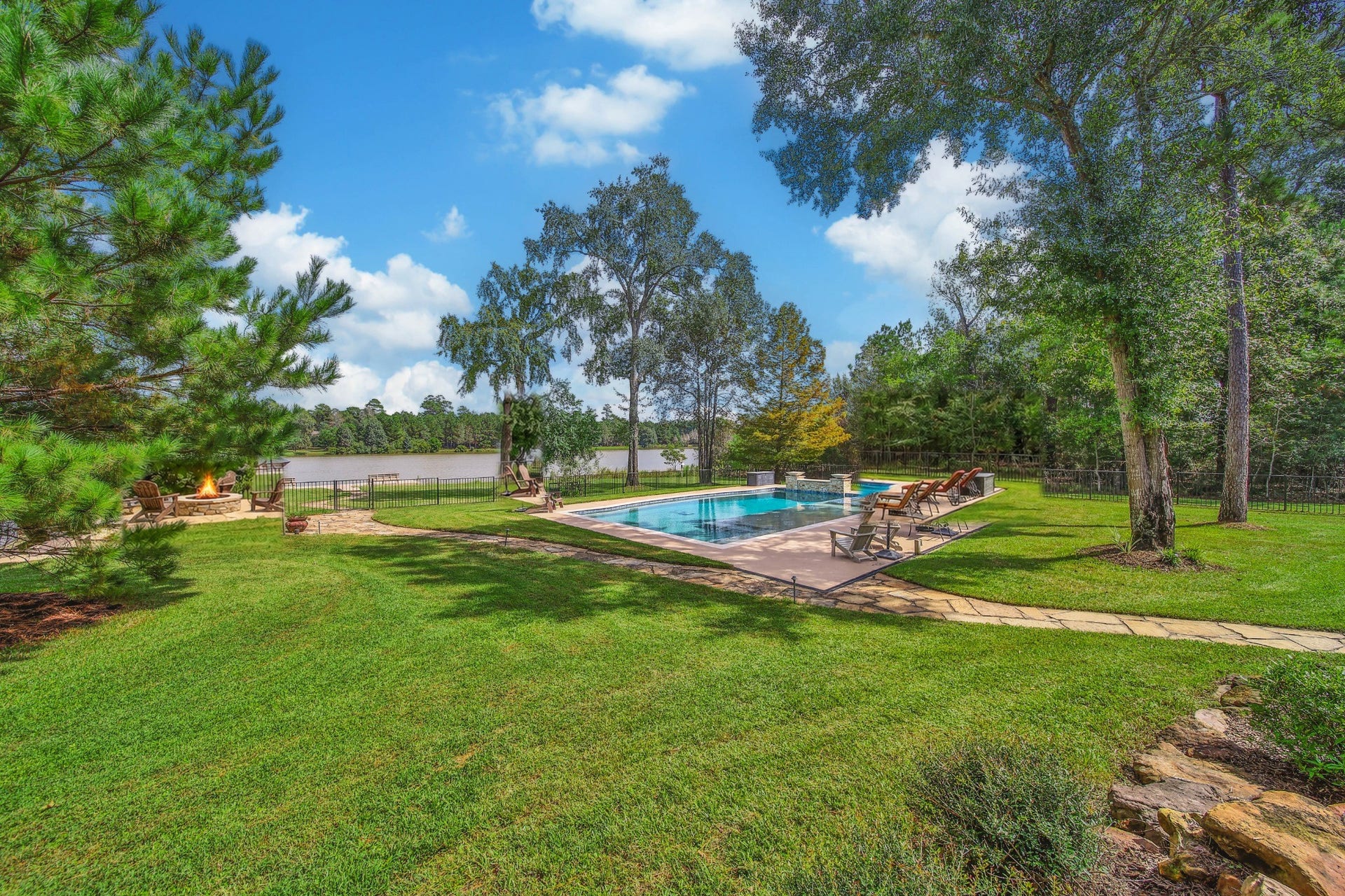 Some days call for a gathering; others call for a quiet walk across the lawn. These landscaped grounds accommodate both, with the pool and lakefront woven into the setting.