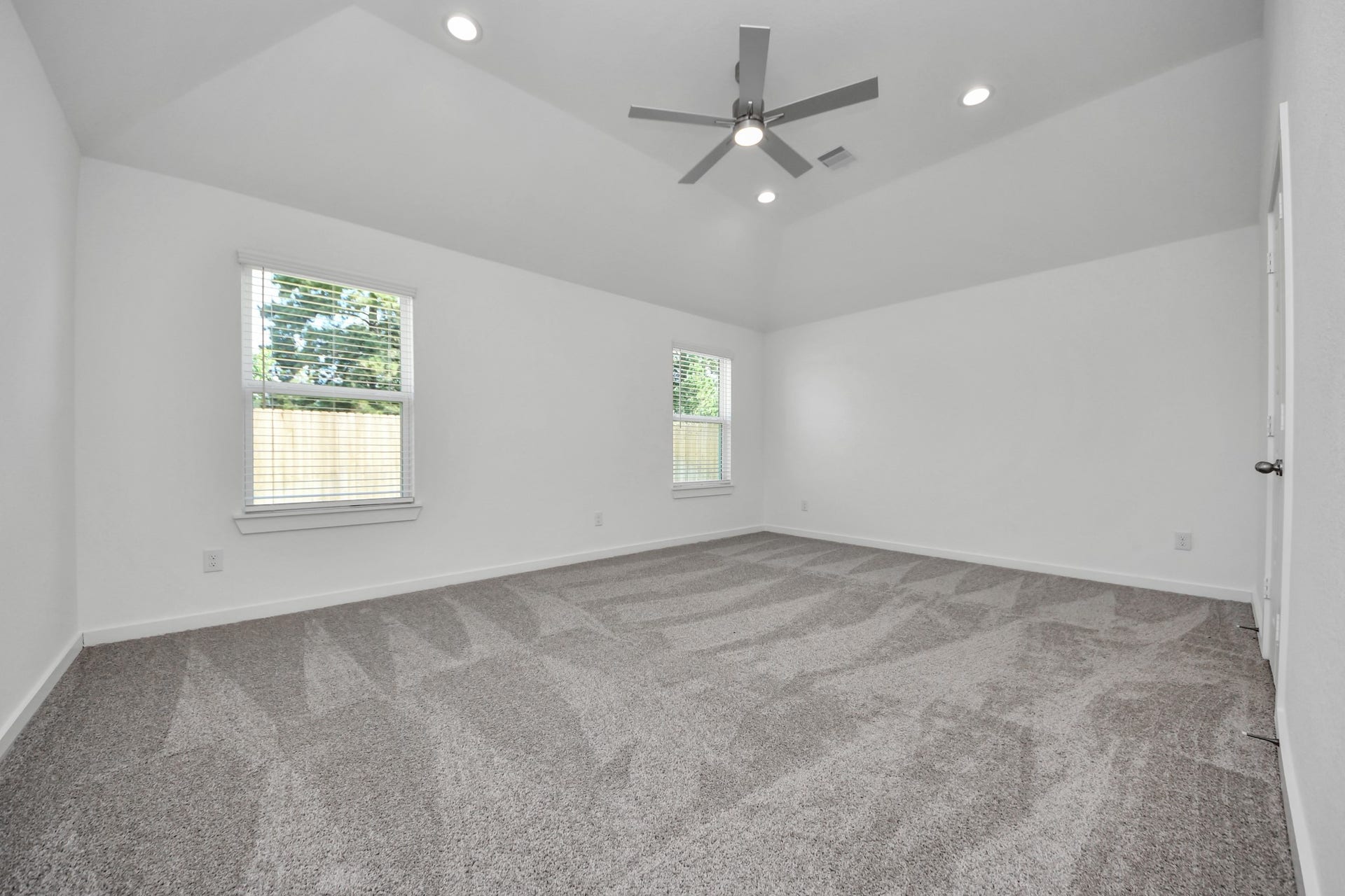 11015 Hosta Stream Drive, Houston, TX 77044 Come and unwind after a long day in this magnificent primary suite! This spacious room features plush carpet, warm paint, high ceilings and large windows with privacy blinds. Sample photo of completed home with similar floor plan. Actual colors and selections may vary.