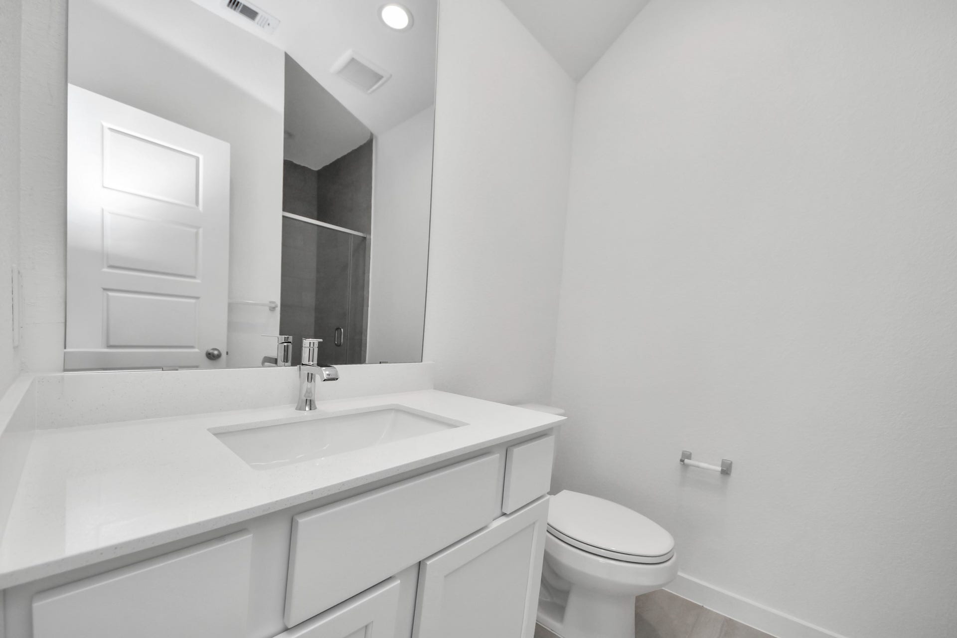 11015 Hosta Stream Drive, Houston, TX 77044 Secondary bath features tile flooring, walk-in shower with tile surround, light stained wood cabinets, beautiful light countertop. Sample photo of completed home with similar floor plan. Actual colors and selections may vary.