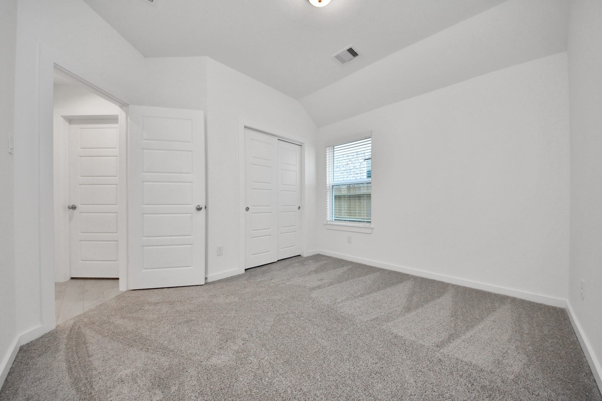 11015 Hosta Stream Drive, Houston, TX 77044 Generously sized secondary bedrooms featuring spacious closets, soft and inviting carpeting underfoot, large windows allowing plenty of natural light, and the added touch of privacy blinds for your personal retreat. Sample photo of completed home with similar floor plan. Actual colors and selections may vary.