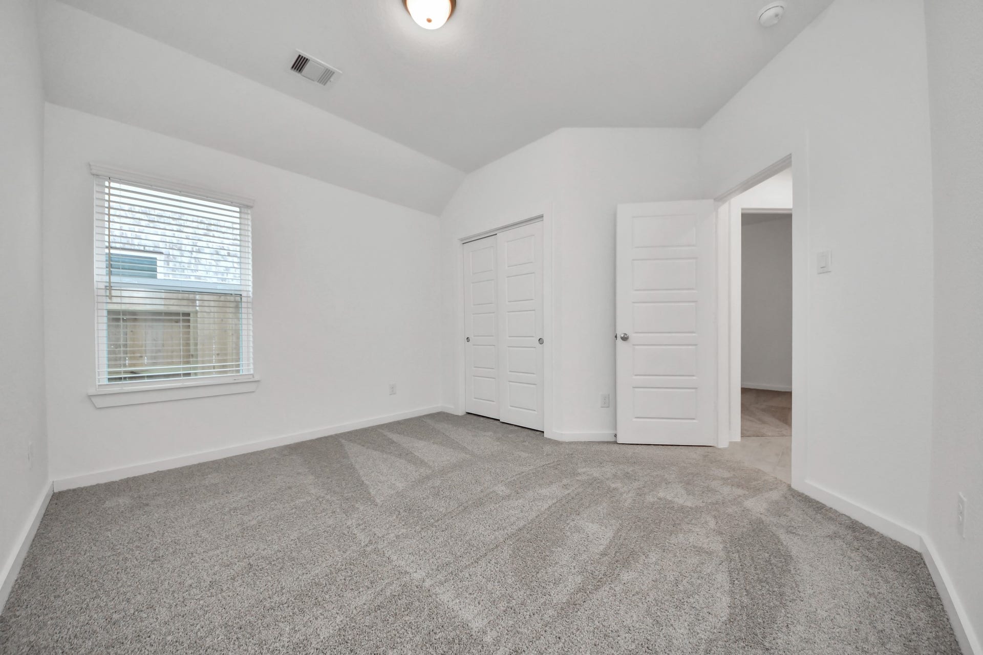 11015 Hosta Stream Drive, Houston, TX 77044 Generously sized secondary bedrooms featuring spacious closets, soft and inviting carpeting underfoot, large windows allowing plenty of natural light, and the added touch of privacy blinds for your personal retreat. Sample photo of completed home with similar floor plan. Actual colors and selections may vary.