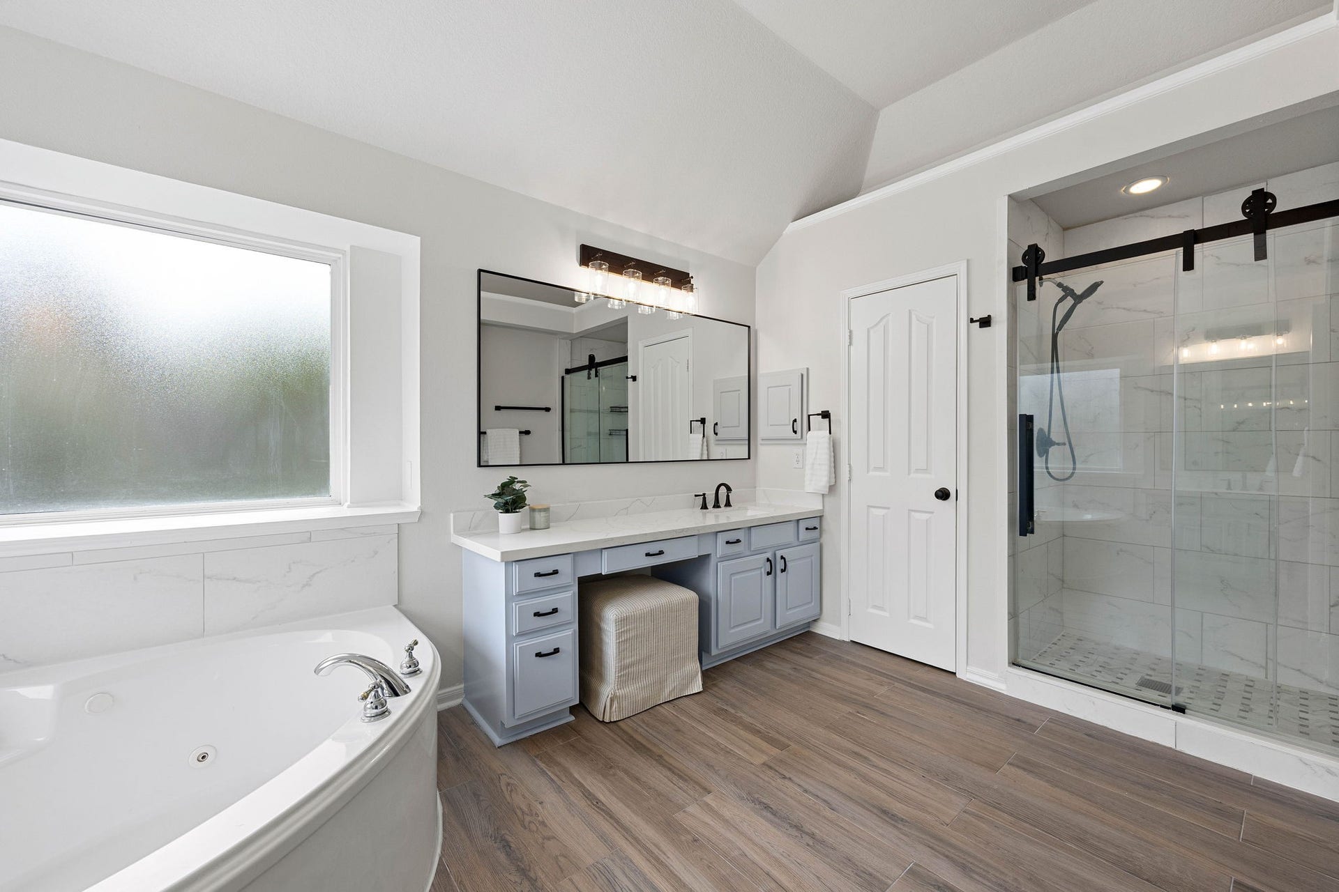 4730 Camden Brook Lane, Katy, TX 77494 Primary bathroom featuring a soaking tub, separate shower, dual vanity area, and abundant natural light.