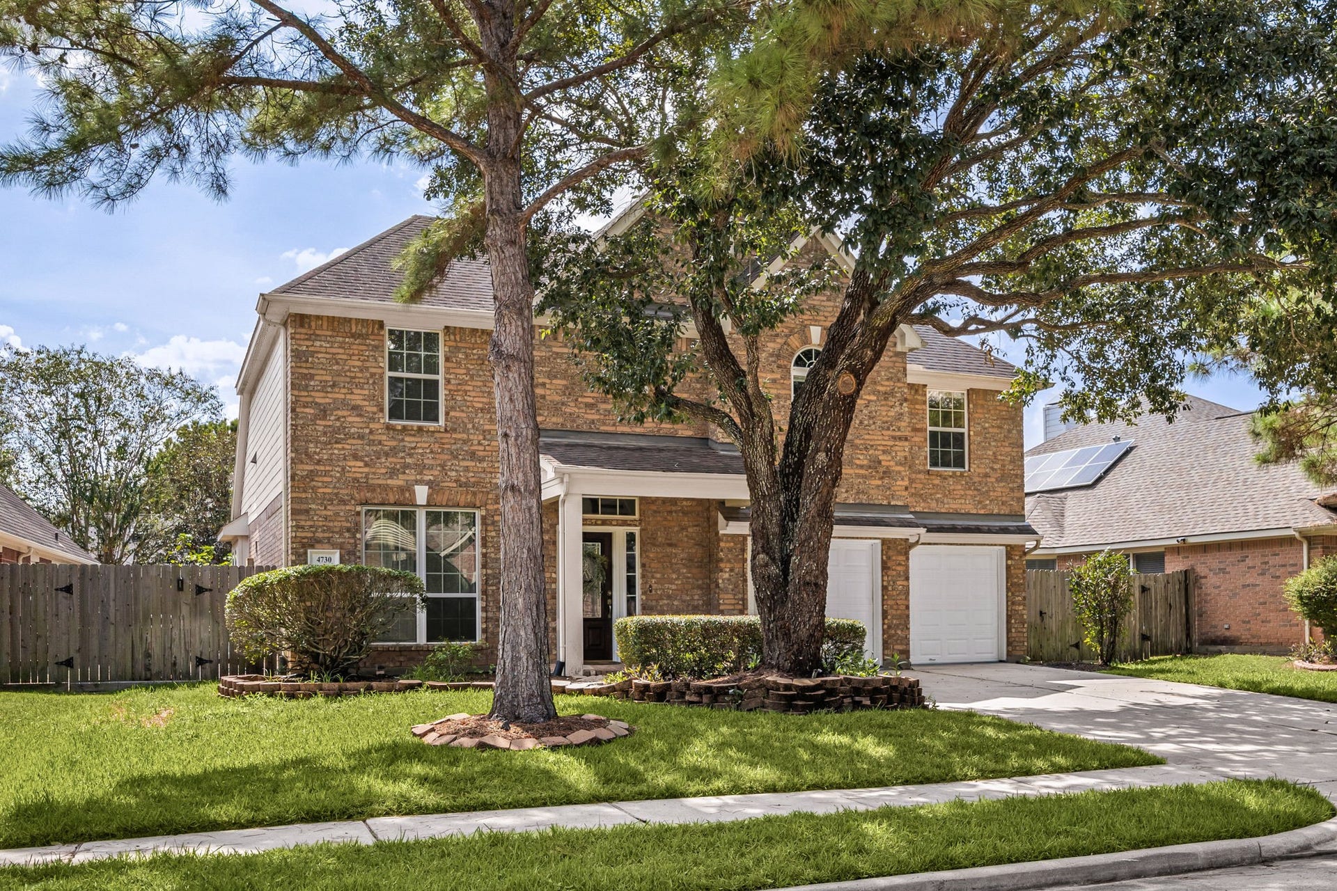 4730 Camden Brook Lane, Katy, TX 77494 Front exterior view highlighting the mature landscaping, spacious driveway, and attached two-car garage.