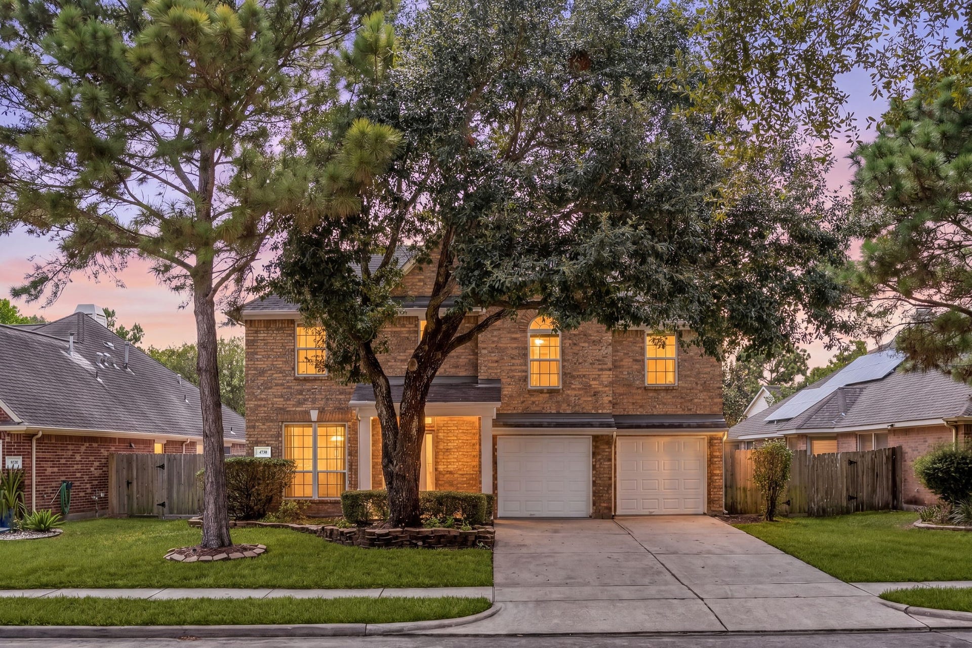 4730 Camden Brook Lane, Katy, TX 77494 Welcoming two-story exterior featuring mature shade trees, an attached two-car garage, and an inviting front entry.