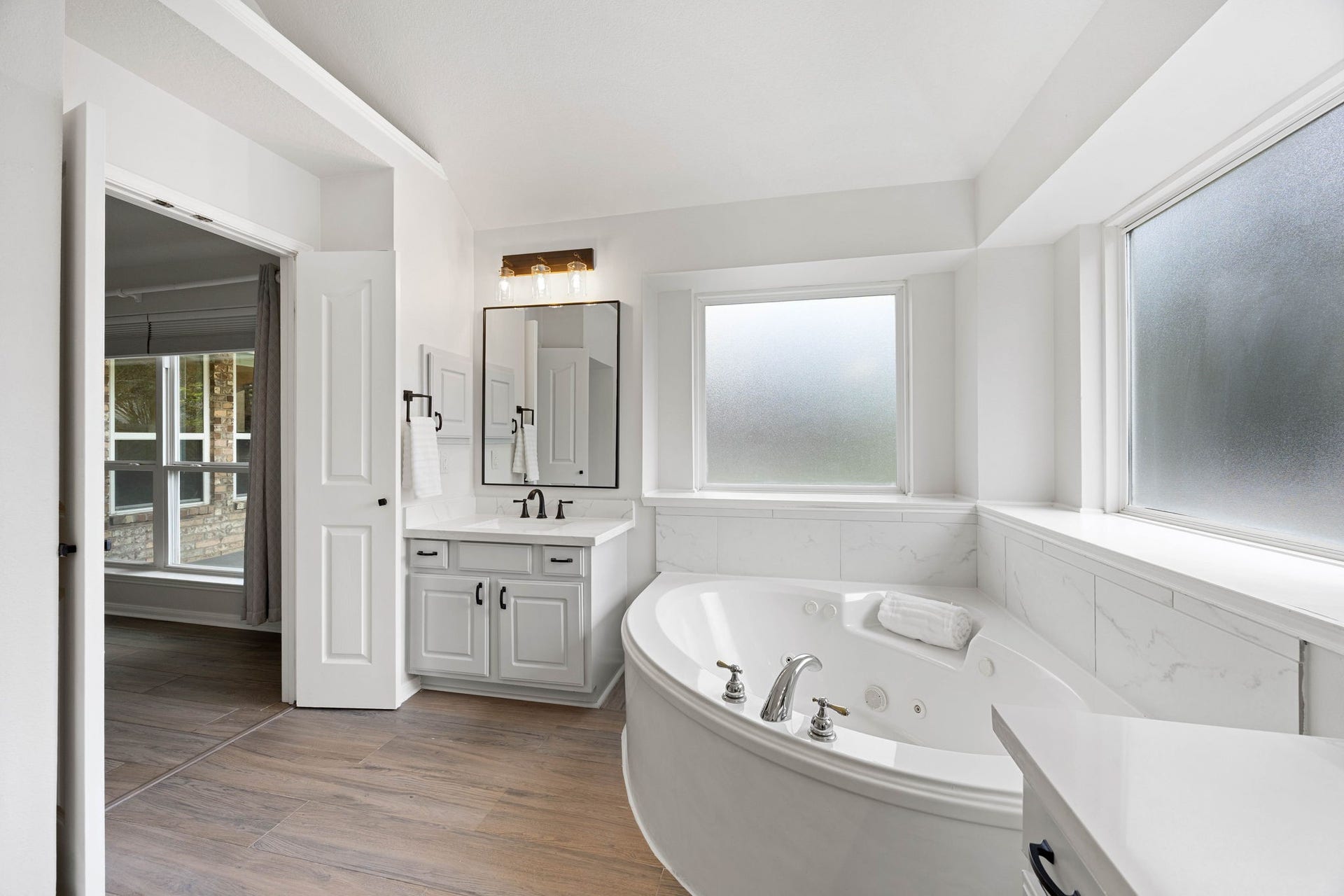 4730 Camden Brook Lane, Katy, TX 77494 Additional primary bathroom view highlighting the soaking tub, dual vanity, large mirror, and bright finishes.