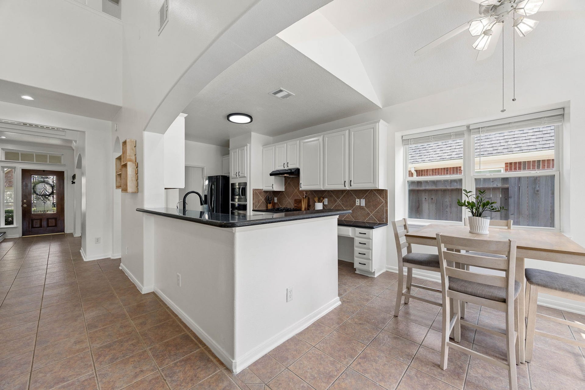 4730 Camden Brook Lane, Katy, TX 77494 Kitchen and living area featuring a breakfast bar, ample cabinetry, and an open layout ideal for everyday living.