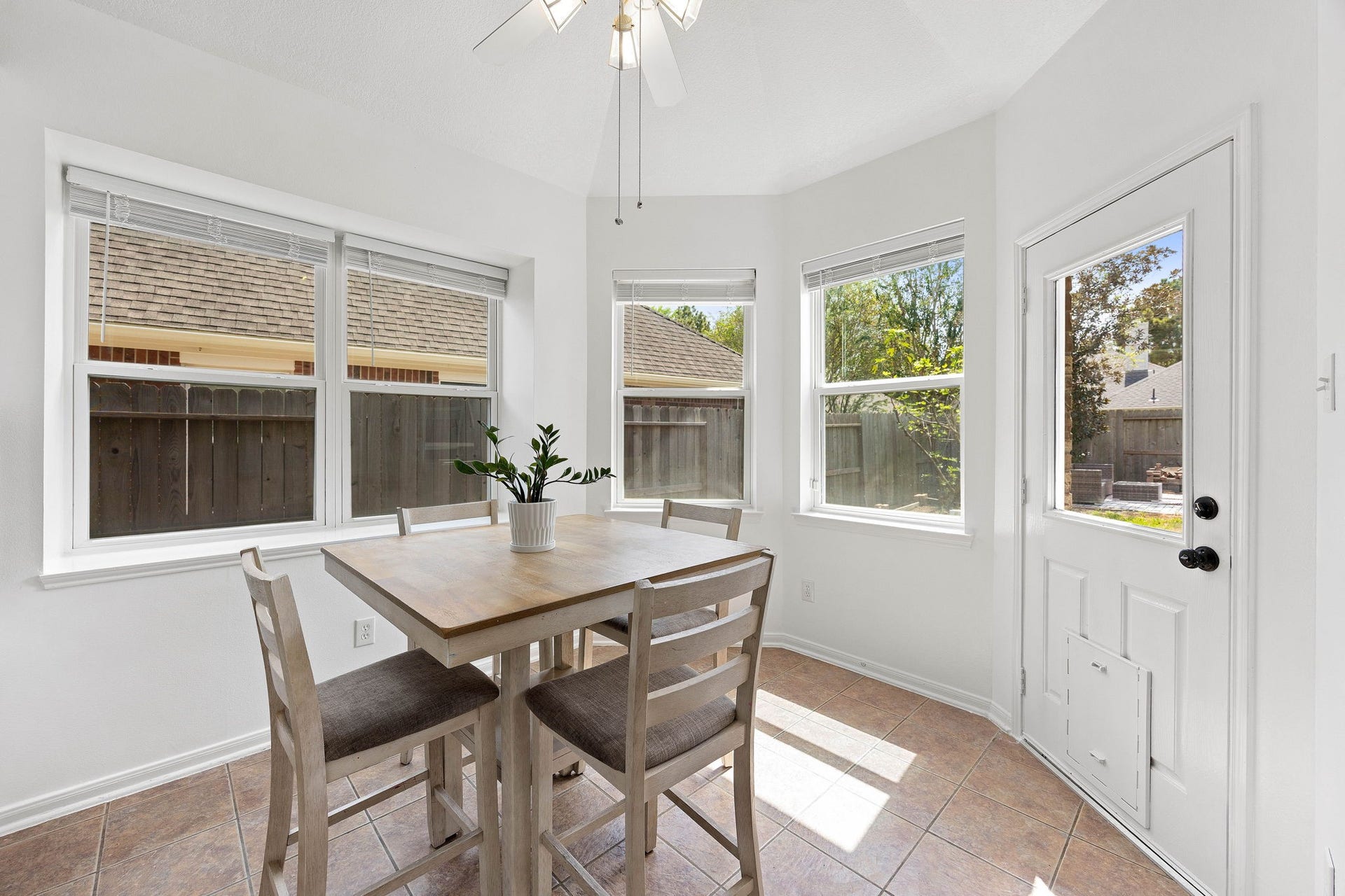 4730 Camden Brook Lane, Katy, TX 77494 Sun-filled breakfast nook featuring multiple windows, tile flooring, and direct access to the outdoor living area.