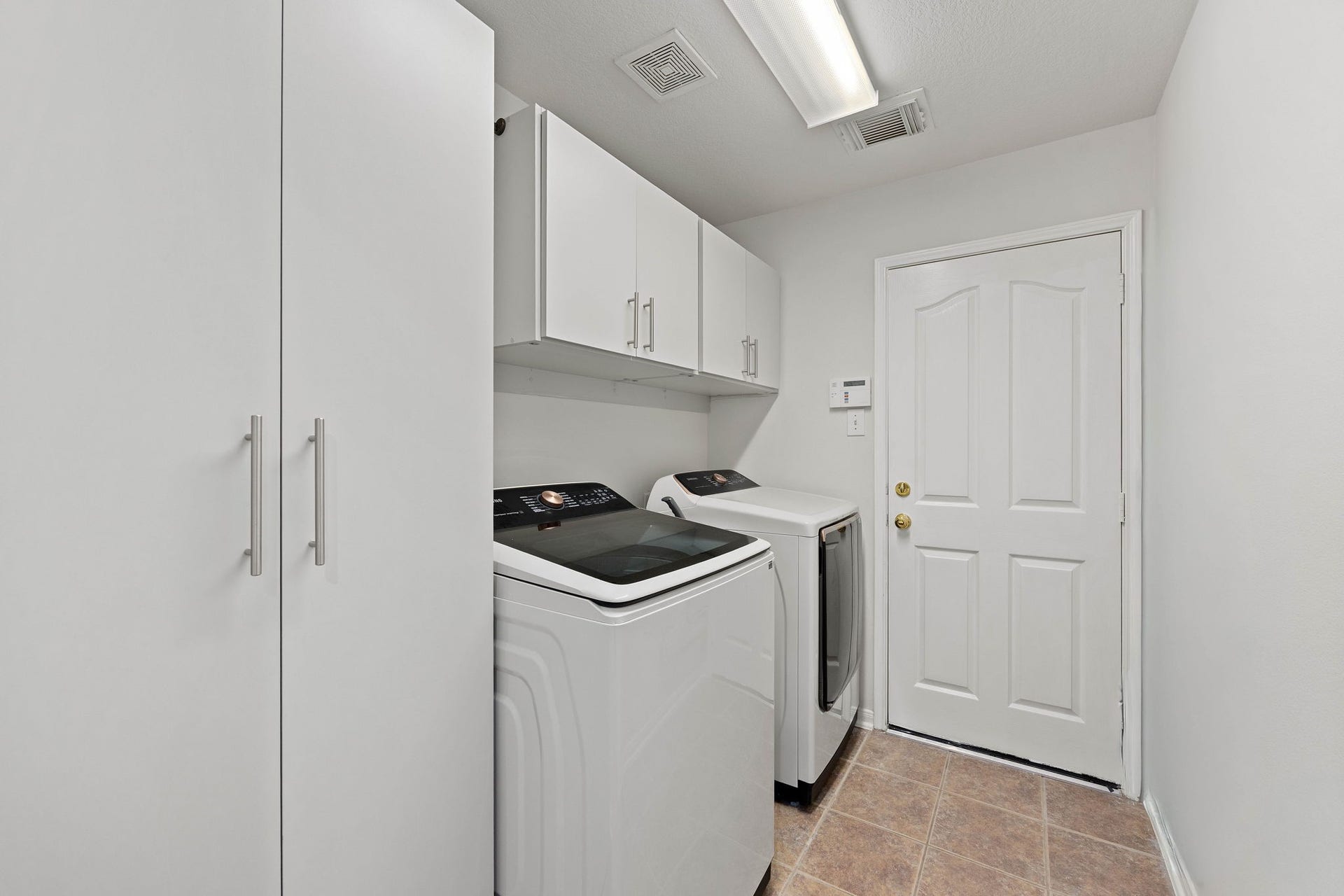 4730 Camden Brook Lane, Katy, TX 77494 Dedicated laundry room featuring built-in cabinetry and space for a full-size washer and dryer.