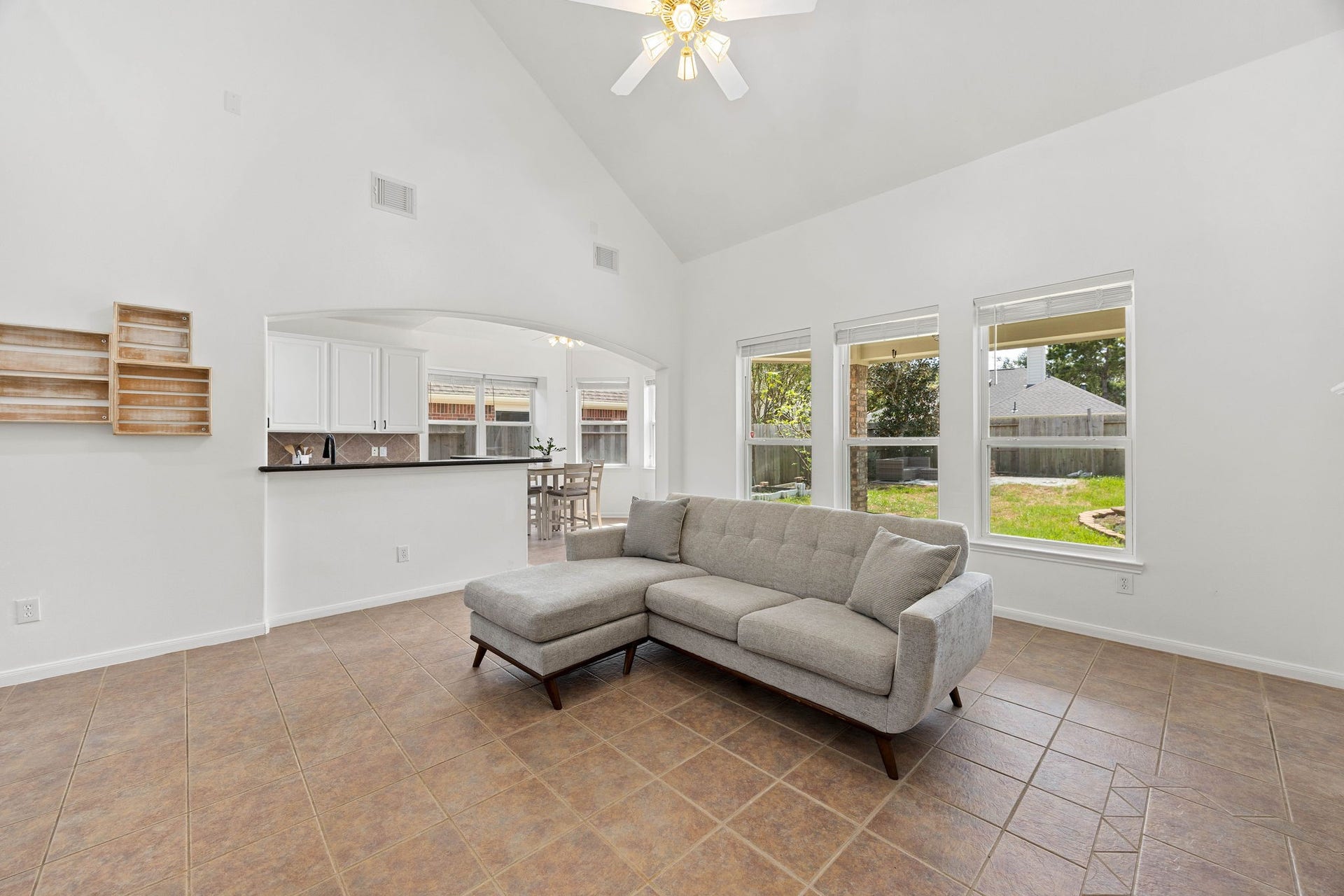 4730 Camden Brook Lane, Katy, TX 77494 Bright family room with a fireplace, large windows, and plenty of space for comfortable seating and entertaining.