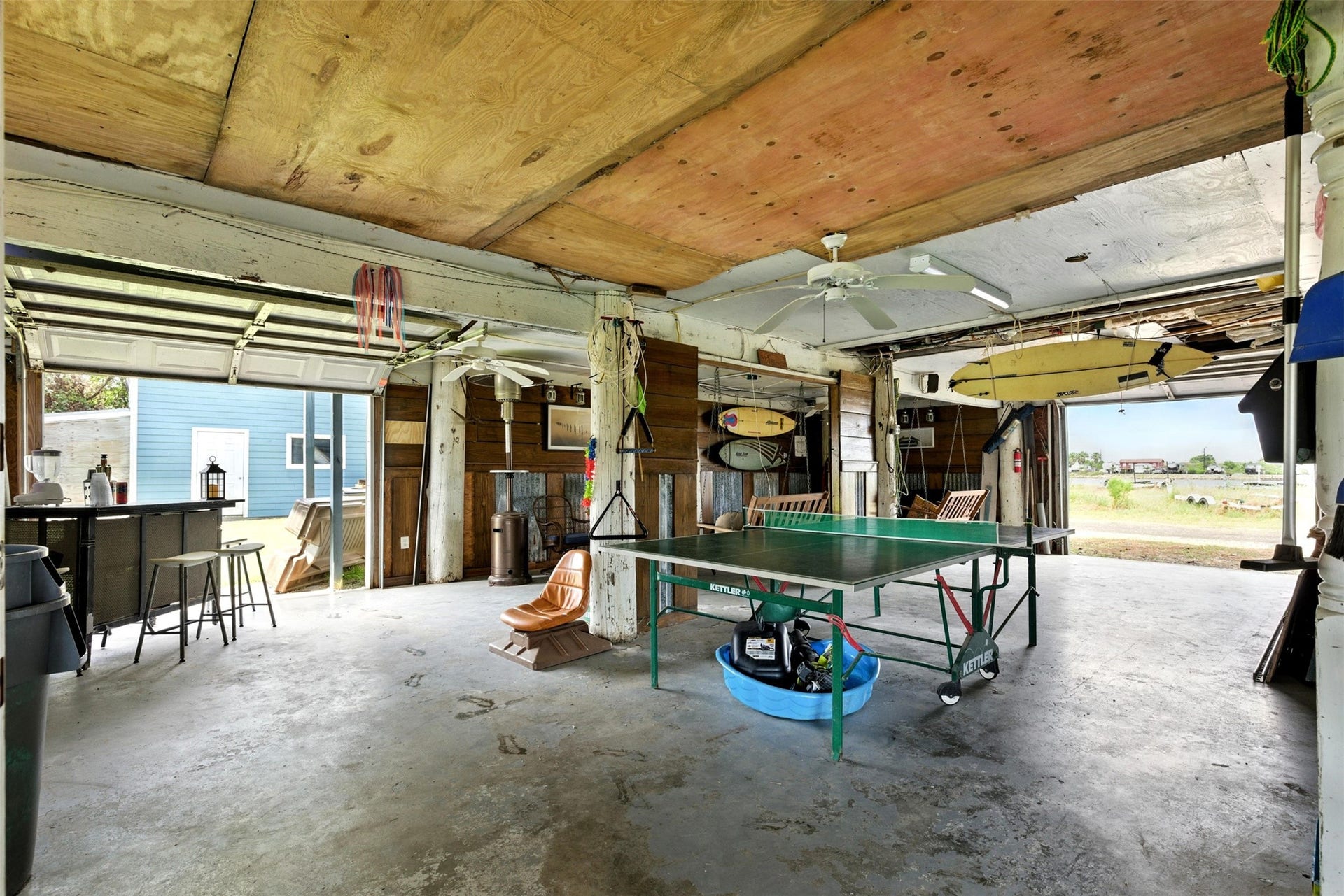 7215 Beau Rue Street, Hitchcock, TX 77563 Garage / Party room below the house with concrete floors and 4 garage doors