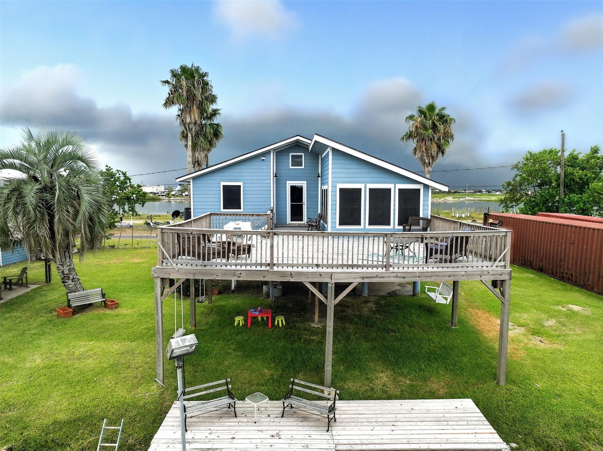 7215 Beau Rue Street, Hitchcock, TX 77563 View of rear of home with upper level deck and lower dock