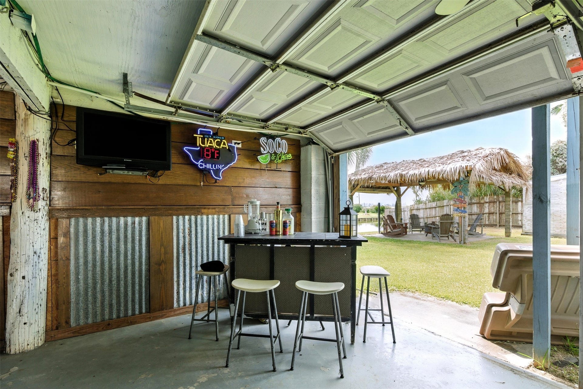 7215 Beau Rue Street, Hitchcock, TX 77563 lower level space with four garage doors, bar and decor included