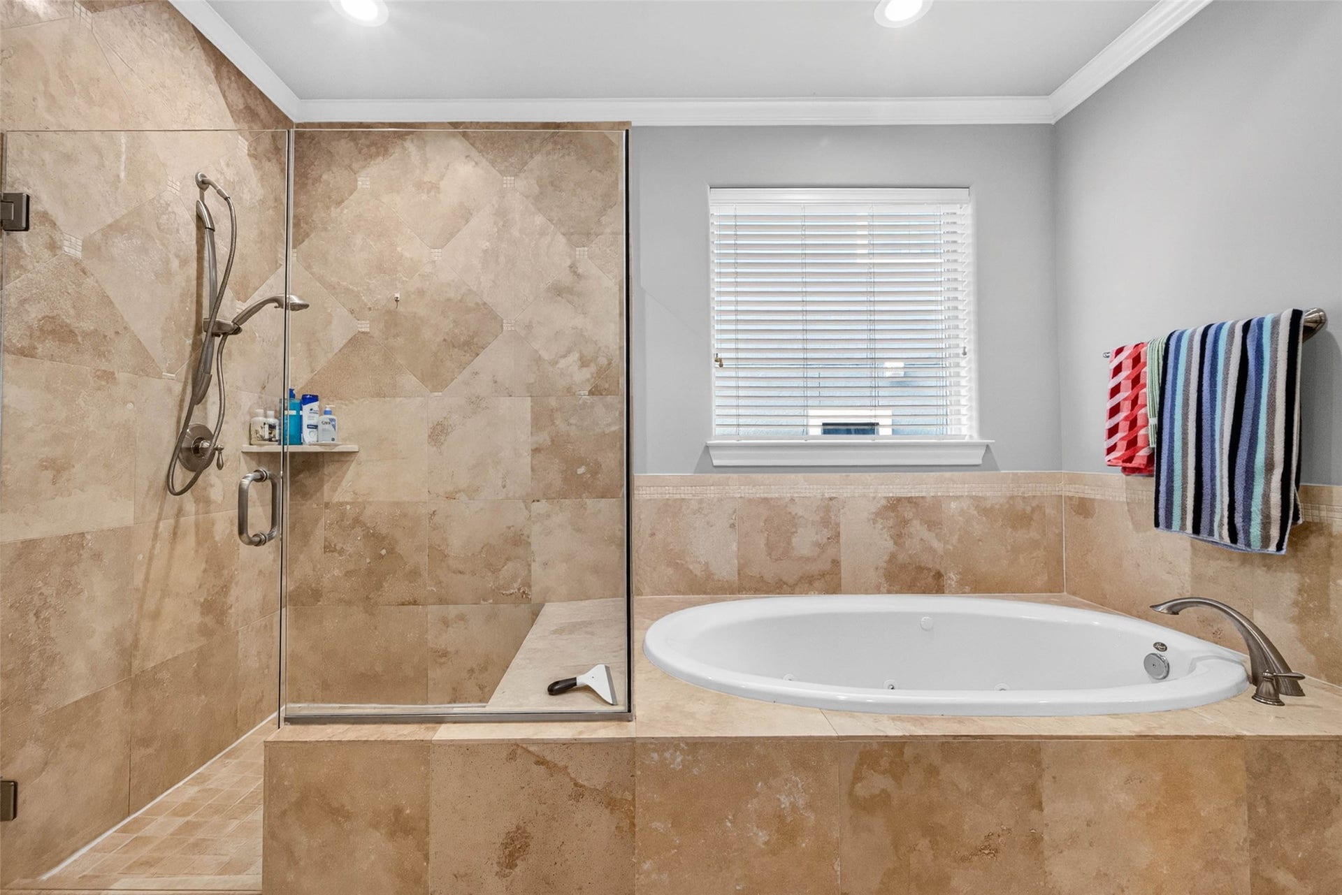 1207 Welch Street, Houston, TX 77006 The primary bath features separate vanity areas, a walk-in shower, and a soaking tub for added comfort and convenience.