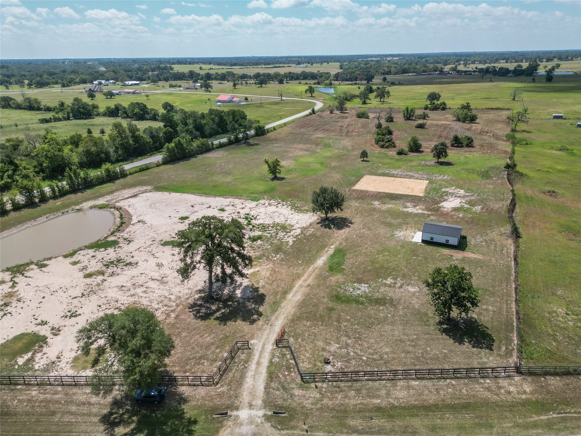 33083 Fm 1736 Road, Hempstead, TX 77445 Aerial view of both tracts highlighting pond, fencing, barn, and open pasture layout.