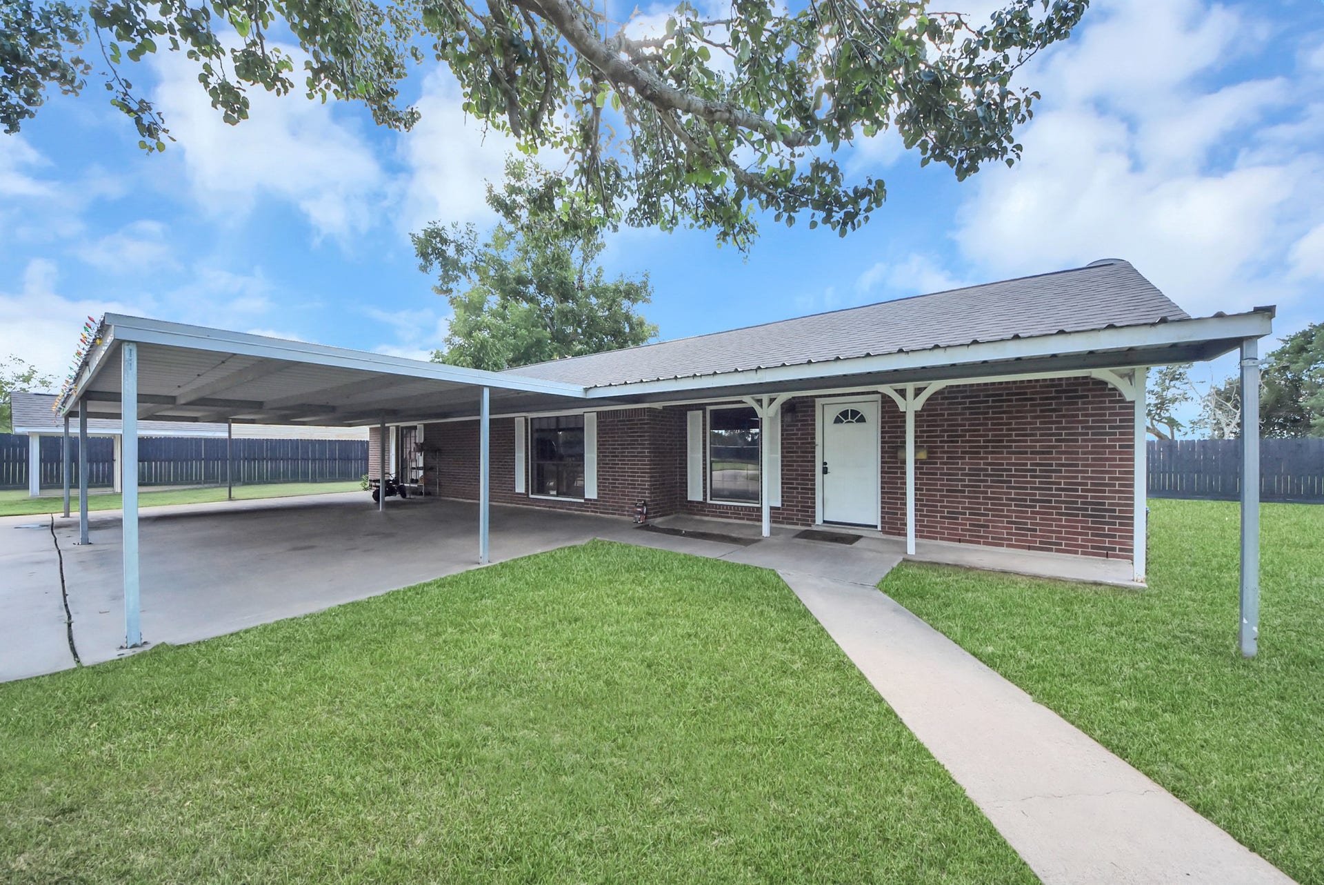 1910 Avenue L, Santa Fe, TX 77510 Can be used as a guest house , office or rental with a newly reinforced carport!!
