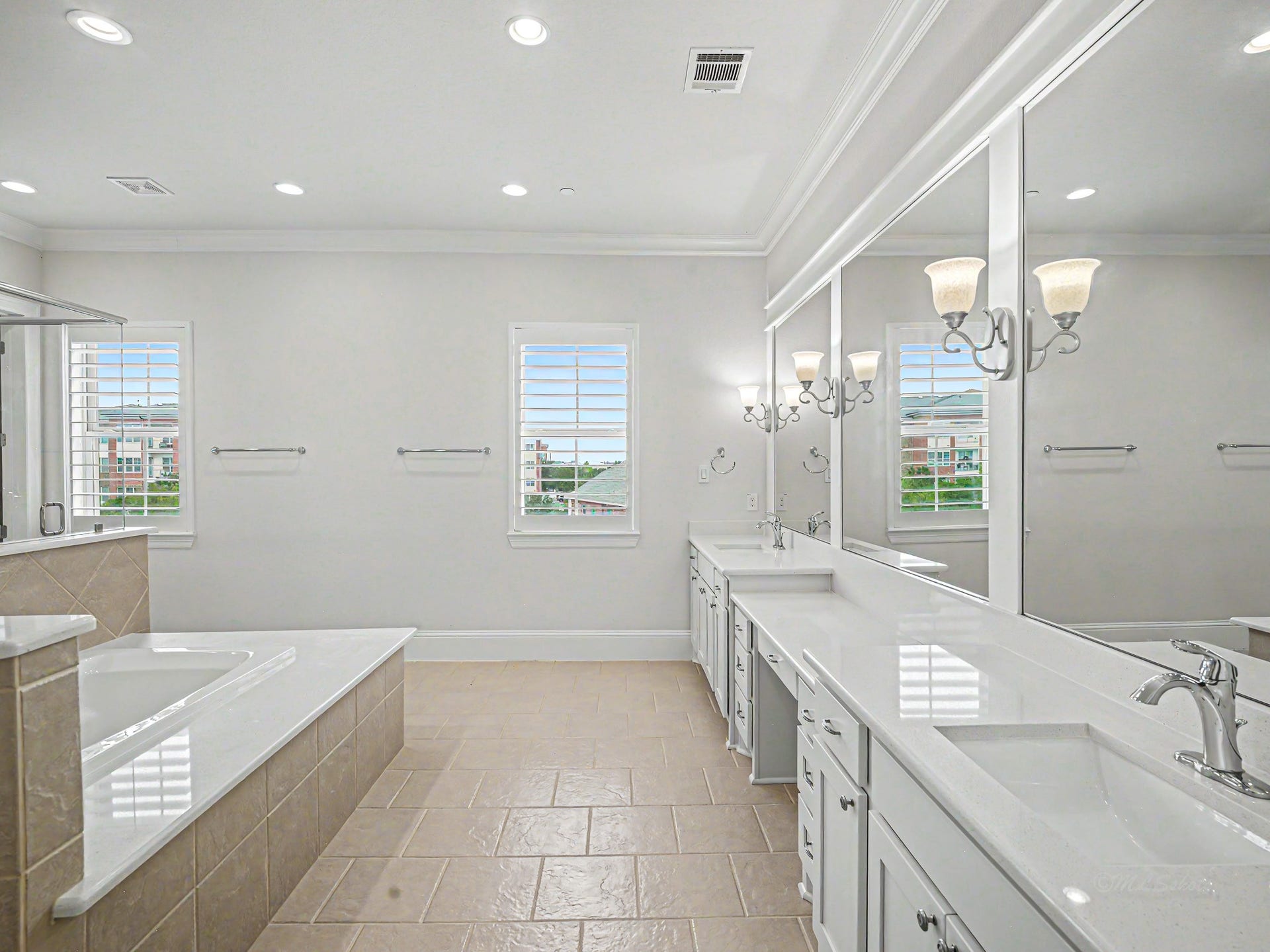 This is your primary bathroom. Double vanities, make-up area, soaking tub & walk-in glass enclosed shower.