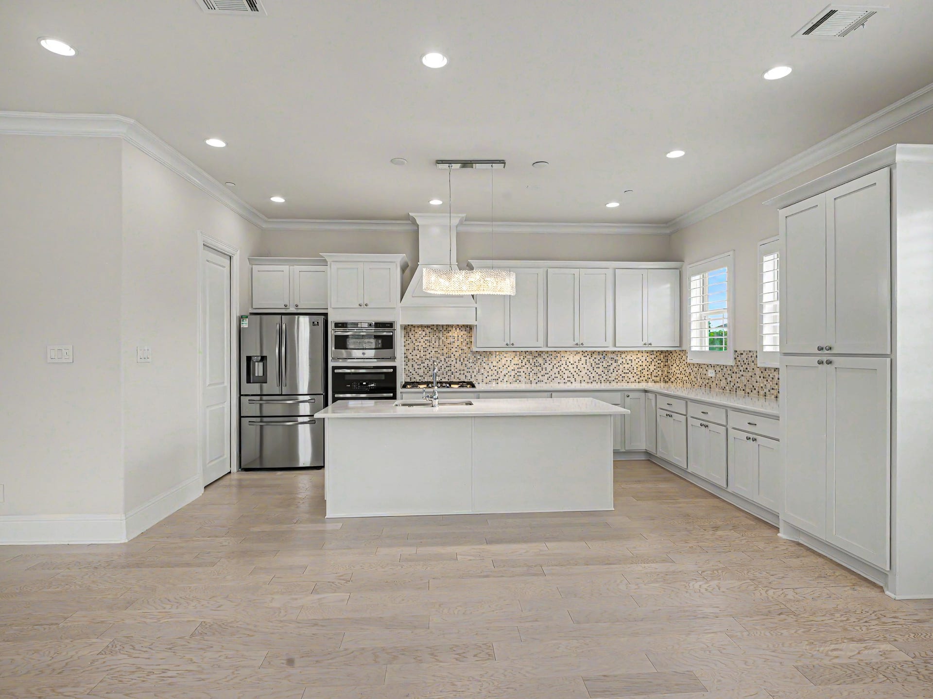 Checkout the cabinet space in this kitchen. Even added an extra four door cabinet just in case! The high-end fixture above the sink was very expensive (Swarovski crystals), gas cooktop, double ovens & refrigerator stays.