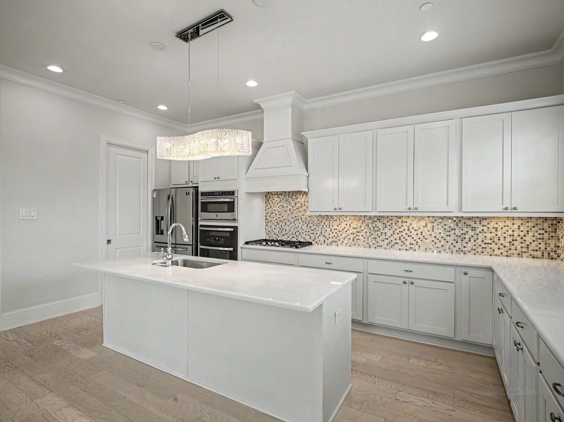 Soft close drawers, under mount lighting, double ovens, microwave, gas cooktop & double door refrigerator complete this outstanding kitchen area.