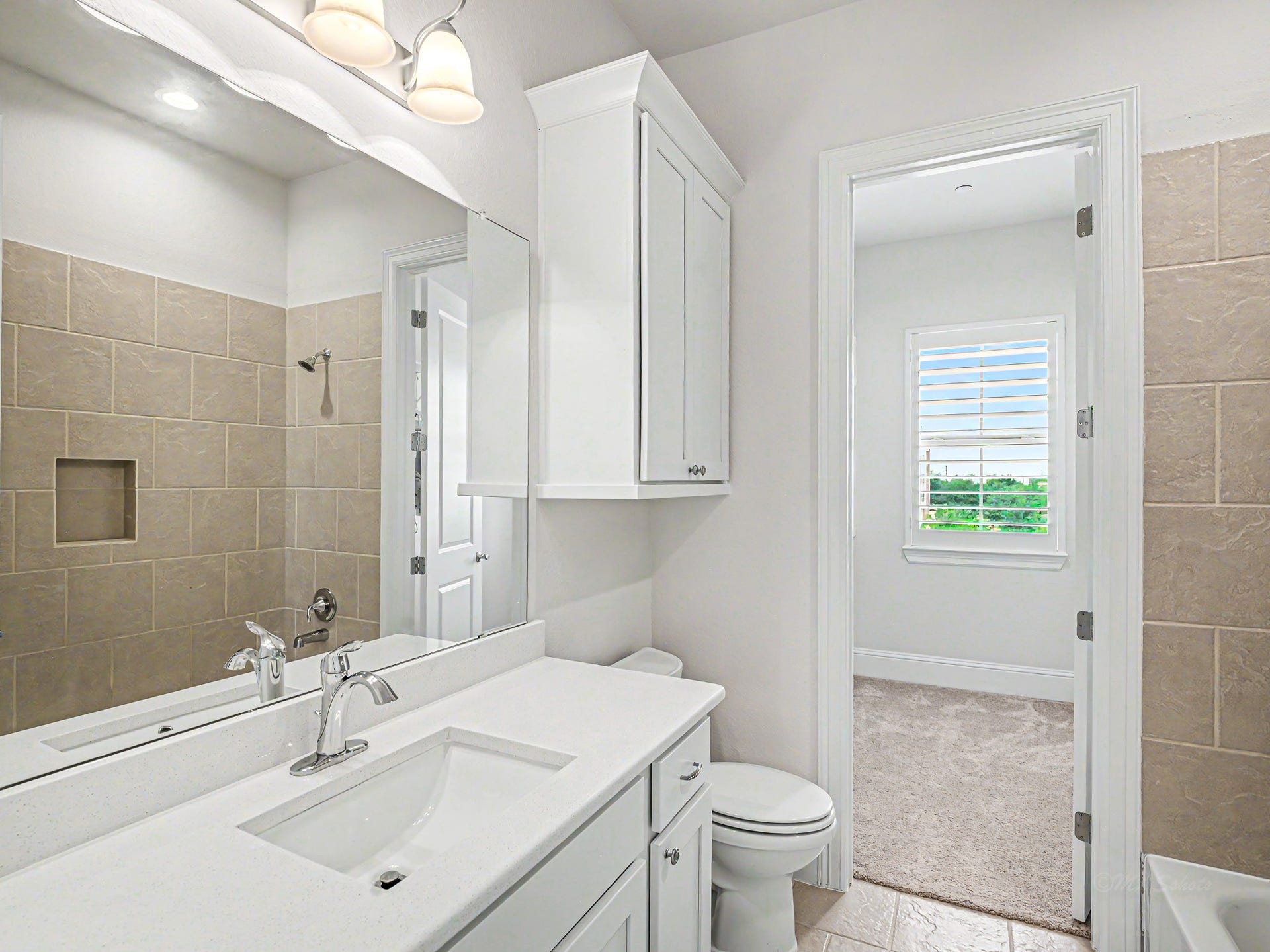 En suite bathroom with tub/shower combo & generous sized closet.