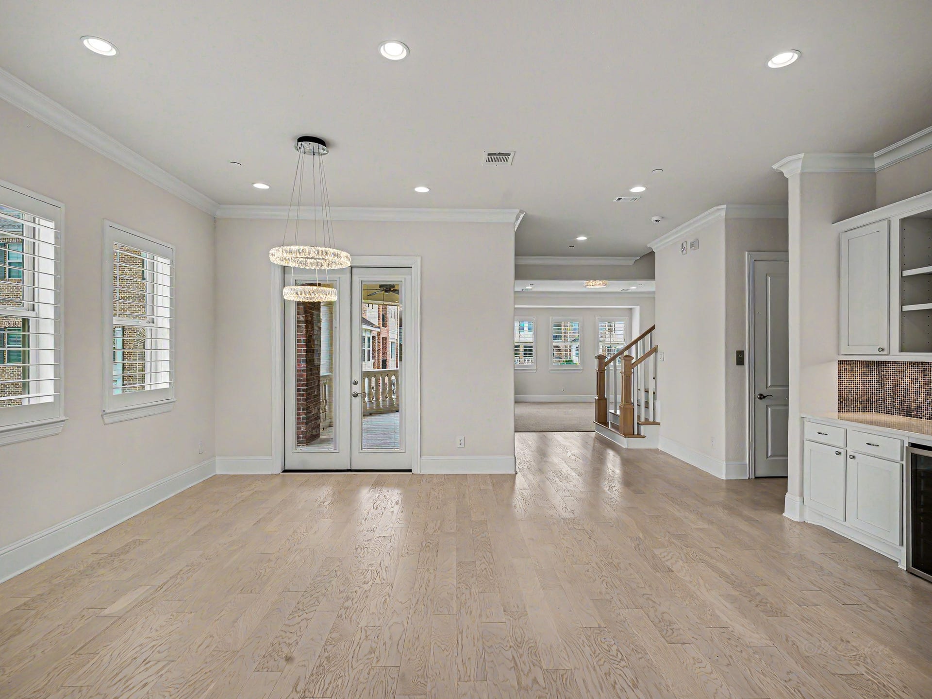 Spacious dining area includes double doors that lead out to the second story balcony.
