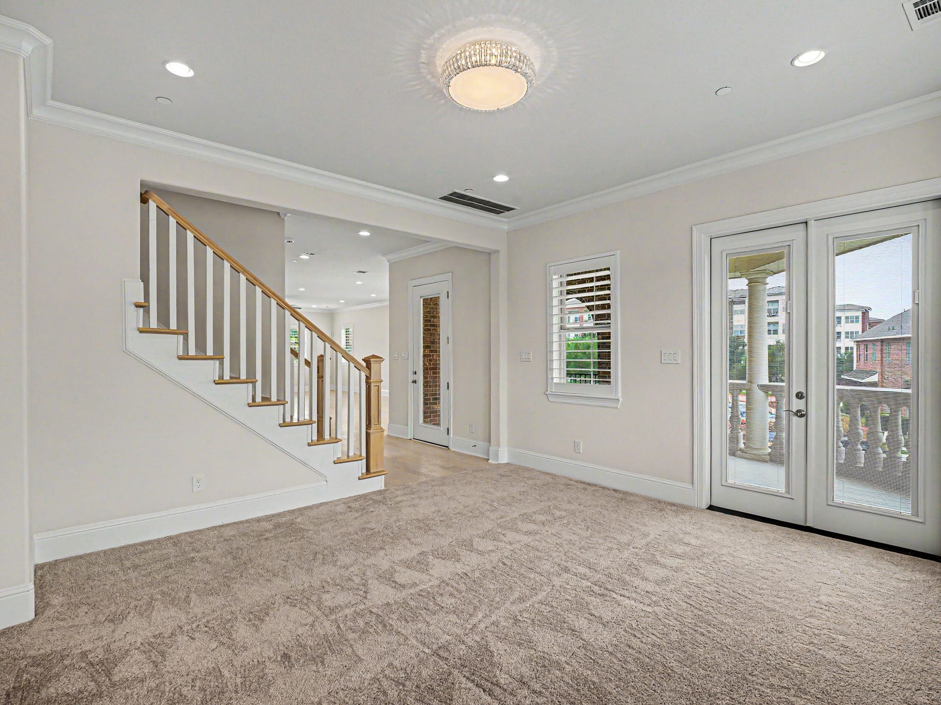 The room also has doors opening onto the second story balcony.