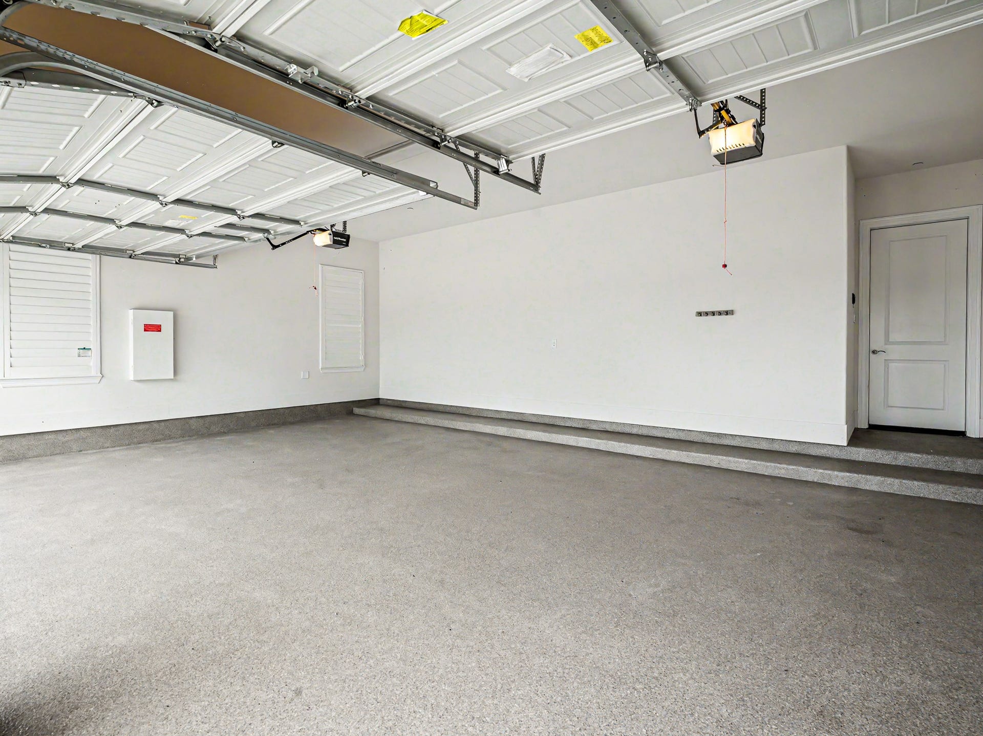 Here is your spacious three car garage with high-end pebble tech flooring. It has two large windows with Plantation Shutters, a two-car garage door & a one car garage door with remotes.