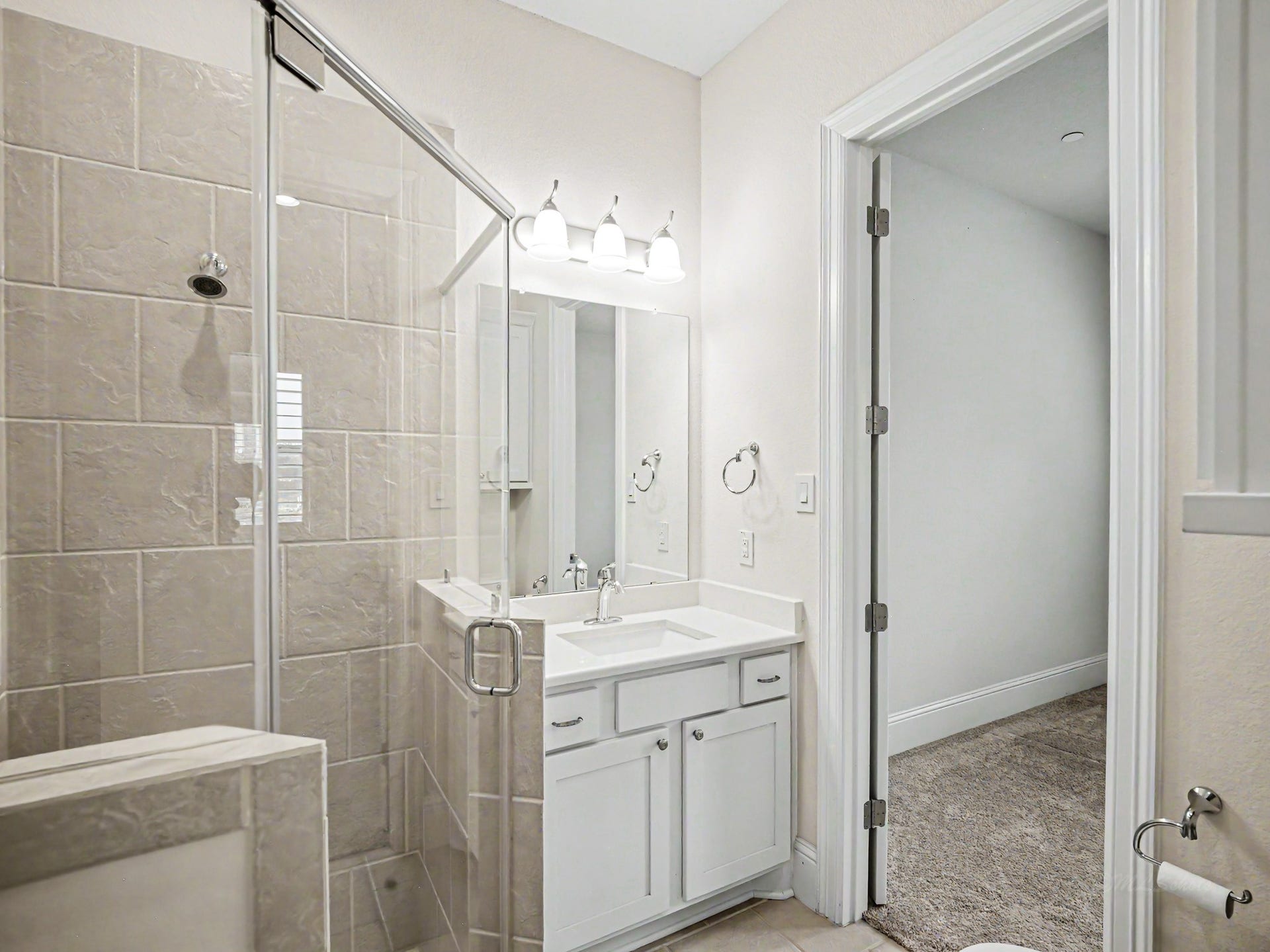 To the right of the foyer is the first-floor bedroom with full walk-in shower with glass enclosure.