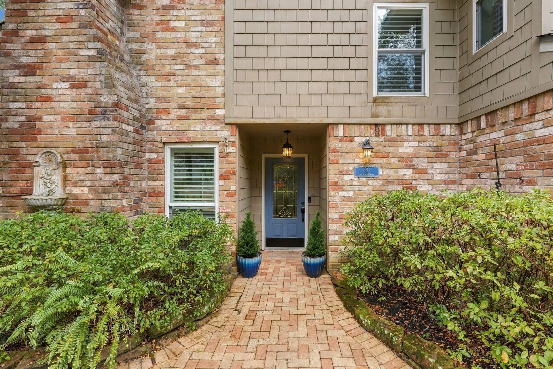 8 Diamond Oak Court, The Woodlands, TX 77381 Brick paver pathway leads up to the front entrance surrounded by beautiful well-maintained landscaping.
