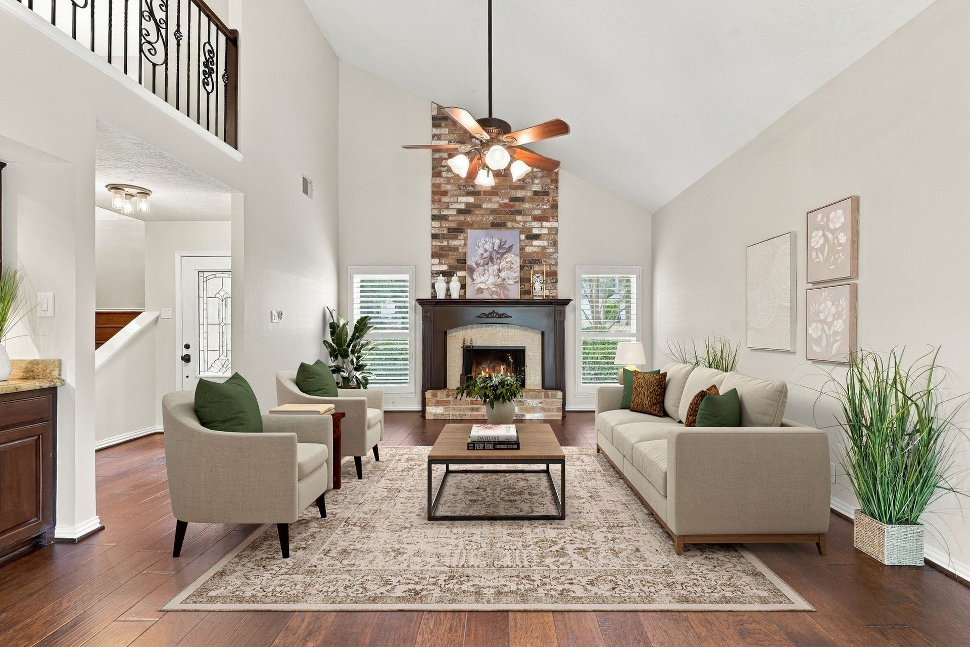 8 Diamond Oak Court, The Woodlands, TX 77381 Living room featuring a beautiful wood burning fireplace, soaring ceilings, and an abundance of natural light. This home has Plantation Shutters on all windows. Virtually staged