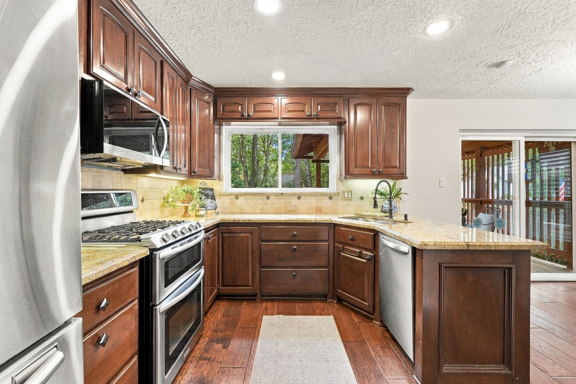 8 Diamond Oak Court, The Woodlands, TX 77381 Another view of the spacious kitchen, highlighting the abundant cabinetry and natural light.
