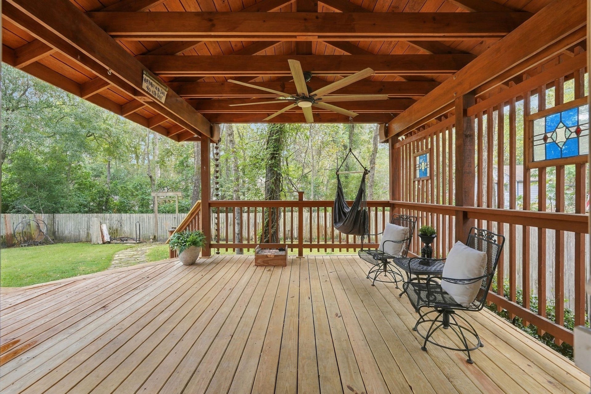 8 Diamond Oak Court, The Woodlands, TX 77381 Covered outdoor patio featuring a wood-paneled ceiling, ceiling fan, and plenty of space for relaxing or entertaining.