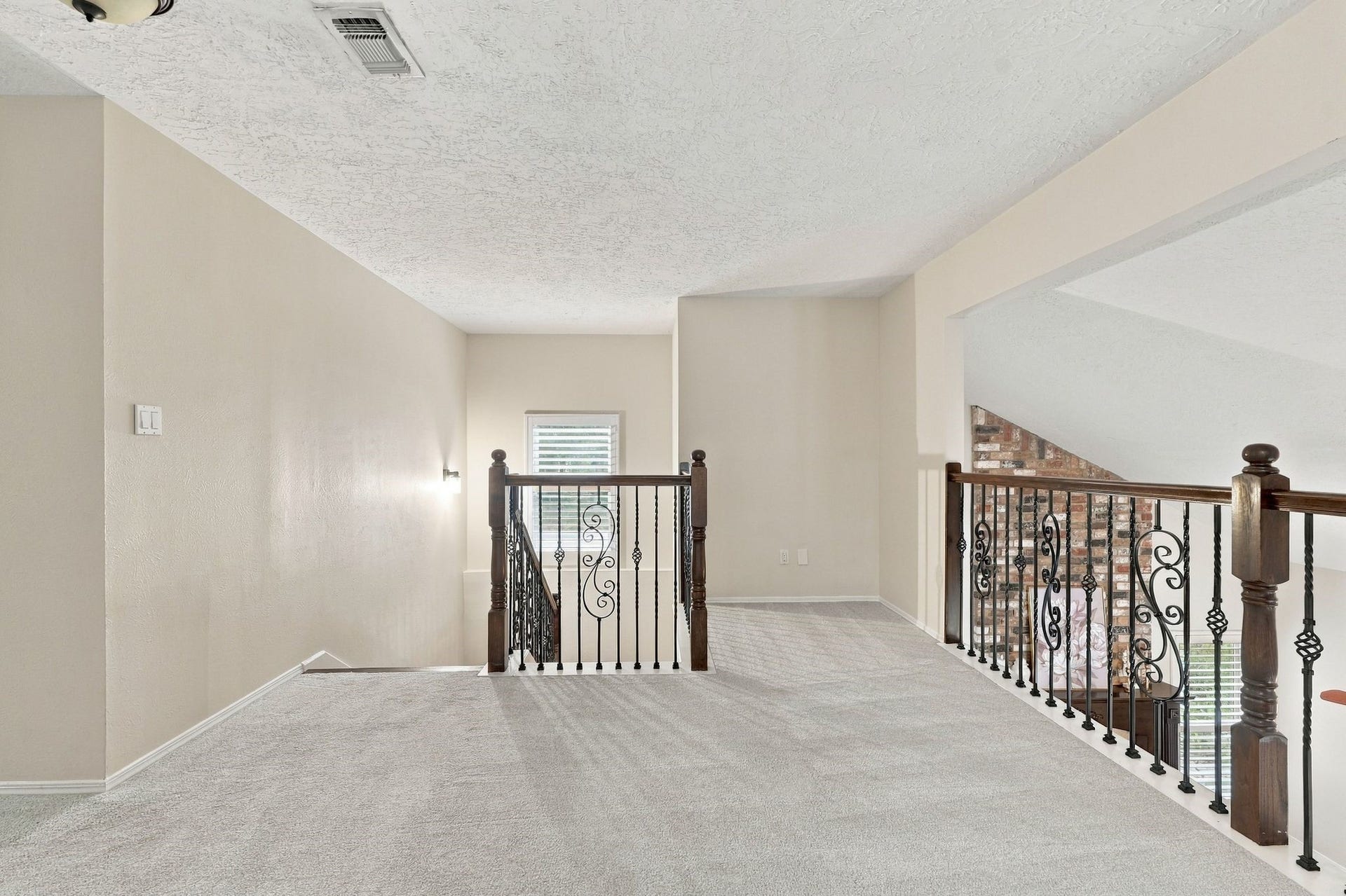 8 Diamond Oak Court, The Woodlands, TX 77381 Spacious upstairs loft area with an open layout overlooking the lower level, offering plenty of possibilities for additional living space.