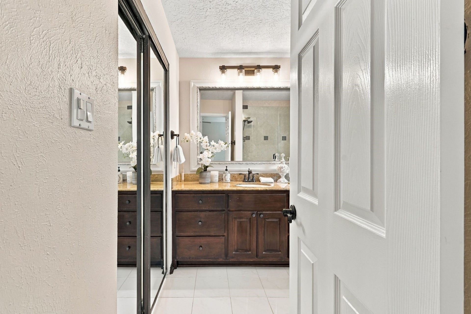 8 Diamond Oak Court, The Woodlands, TX 77381 Entrance to the primary bathroom, featuring a granite topped spacious vanity.
