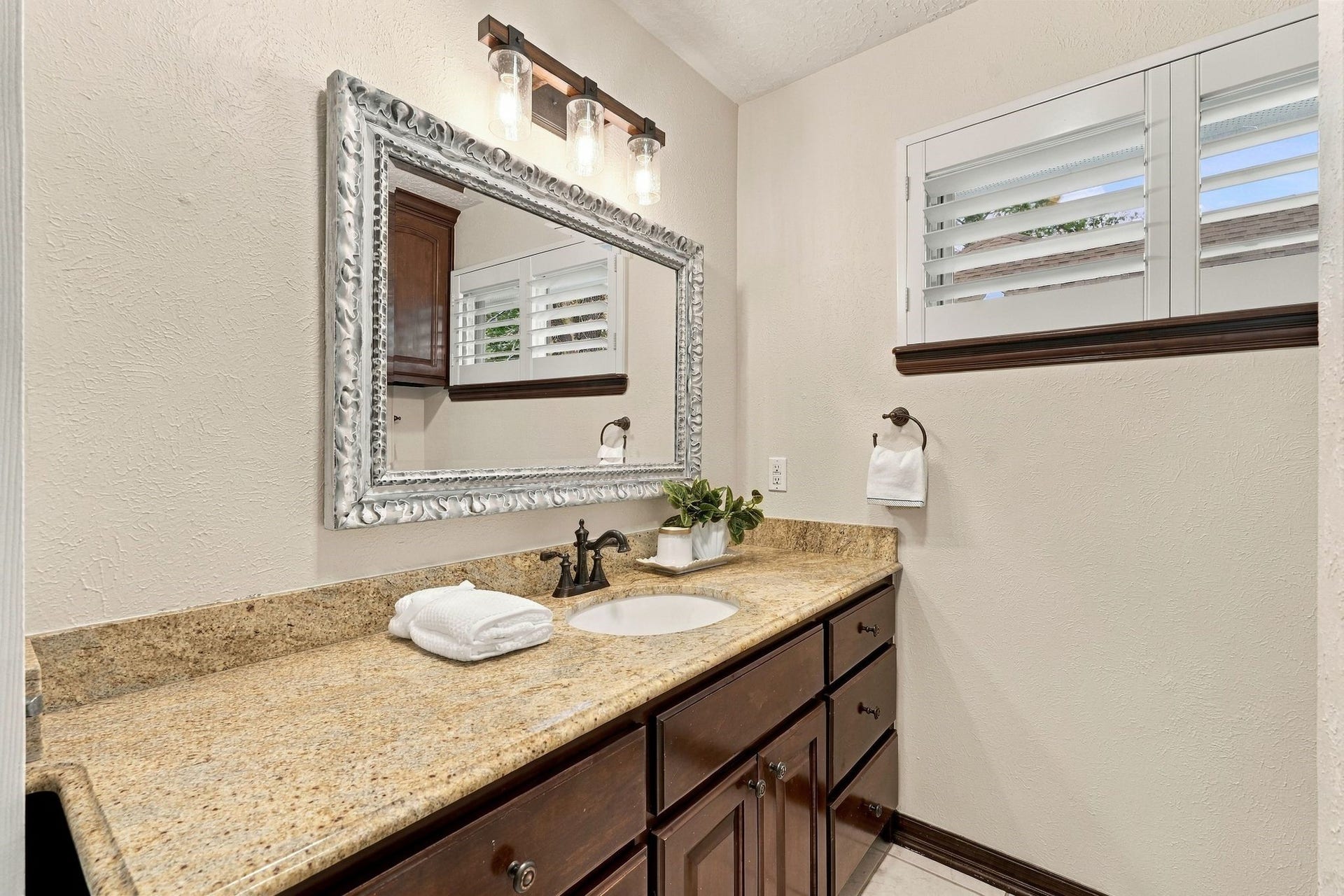 8 Diamond Oak Court, The Woodlands, TX 77381 Another view of the bathroom, showcasing the generous counter space, large mirror, and natural light.
