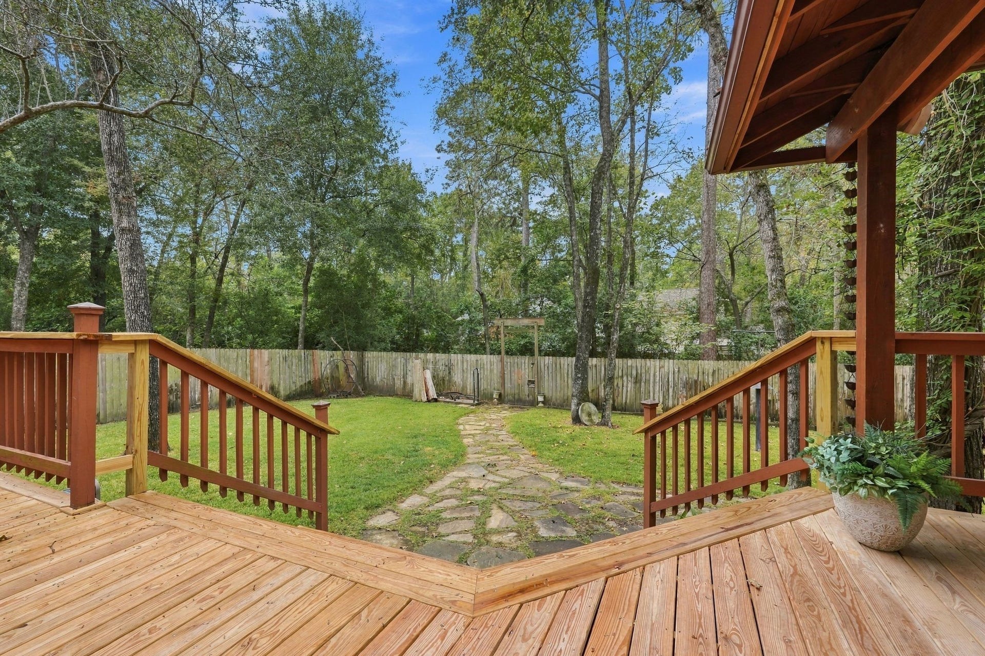 8 Diamond Oak Court, The Woodlands, TX 77381 View from the deck overlooking the spacious backyard and peaceful wooded surroundings.