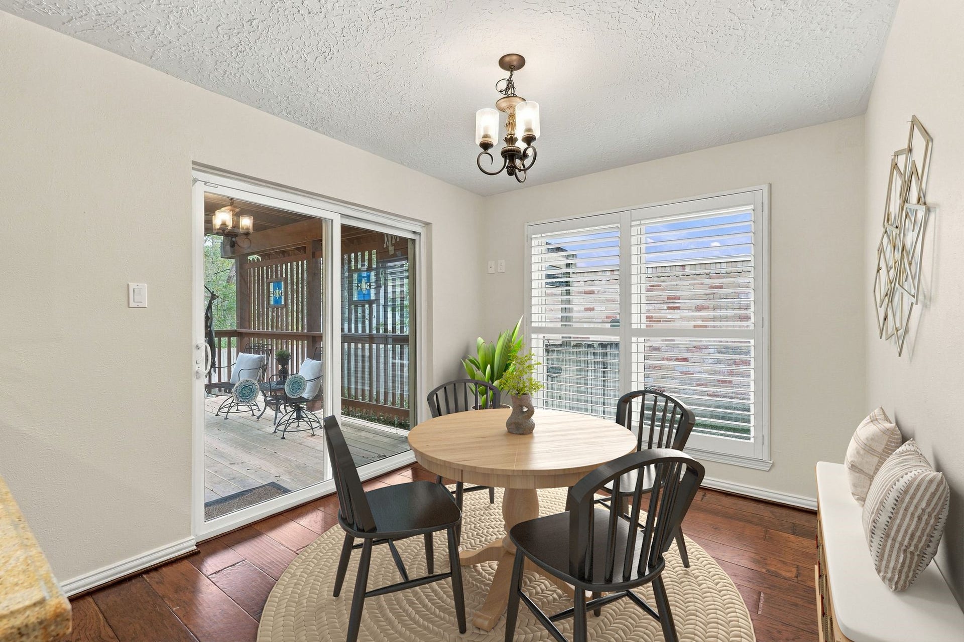 8 Diamond Oak Court, The Woodlands, TX 77381 Bright dining area featuring large windows and easy access to the covered deck and outdoor space. Virtually staged