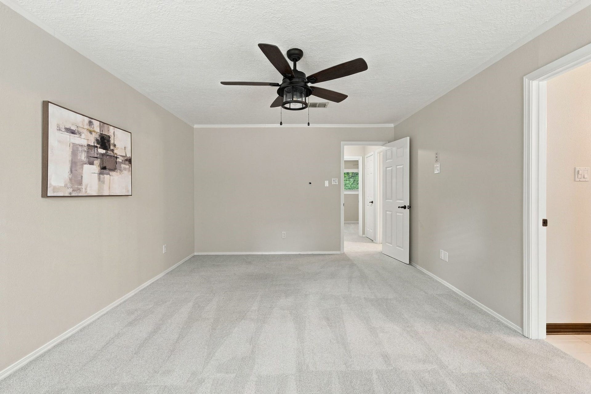 8 Diamond Oak Court, The Woodlands, TX 77381 Spacious primary bedroom with a ceiling fan and plenty of room to create your own relaxing retreat.