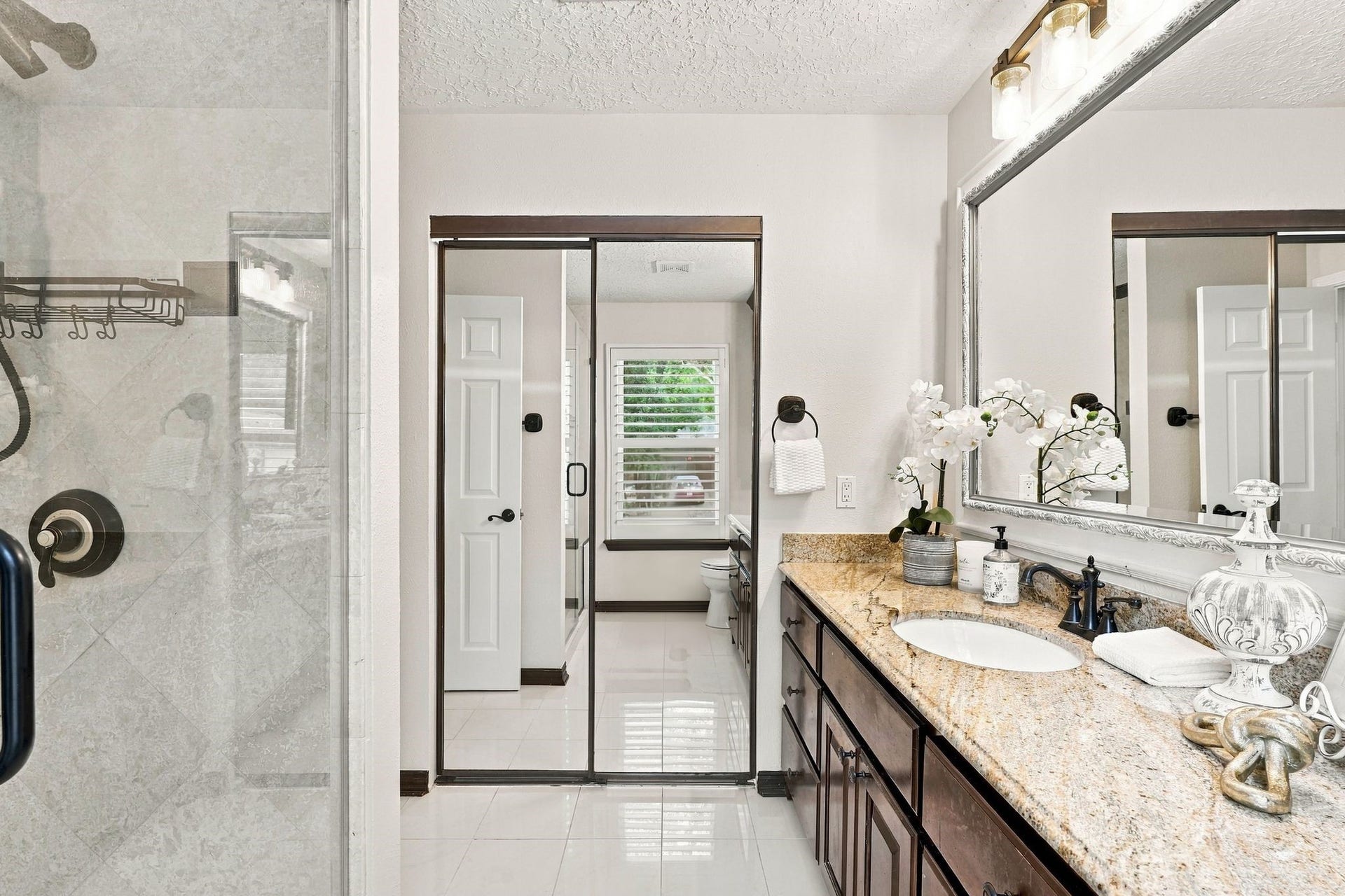 8 Diamond Oak Court, The Woodlands, TX 77381 Another view of the primary bathroom. Primary closet with built-ins behind the mirrored doors.