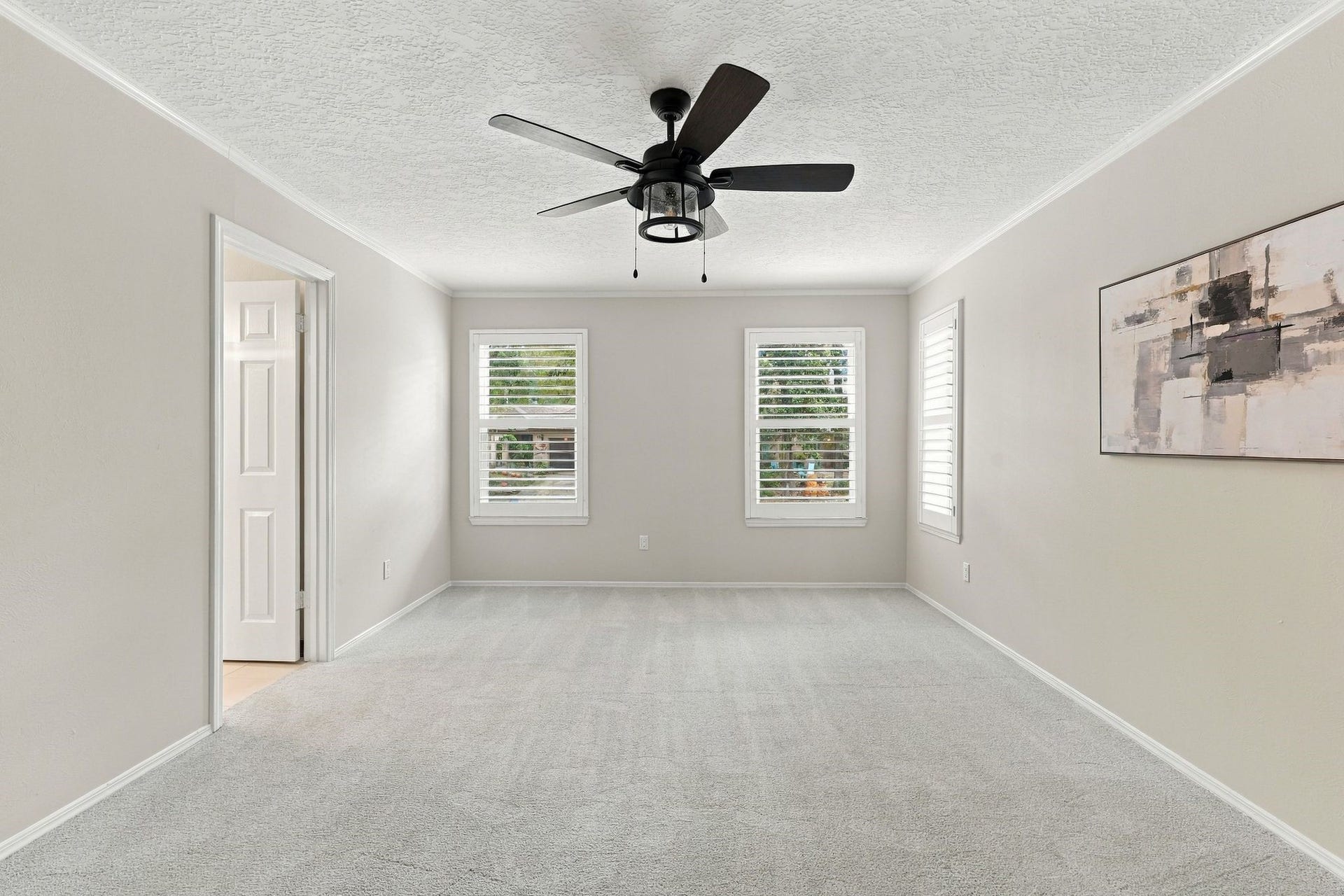 8 Diamond Oak Court, The Woodlands, TX 77381 Another angle of the primary bedroom, highlighting its generous space and natural light. Notice the Plantation Shutters - so elegant!