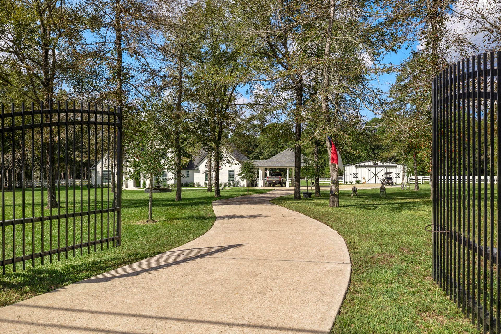 31219 Edgewater Drive, Magnolia, TX 77354 Wrought iron gated entry and long driveway add privacy to an already serene setting.