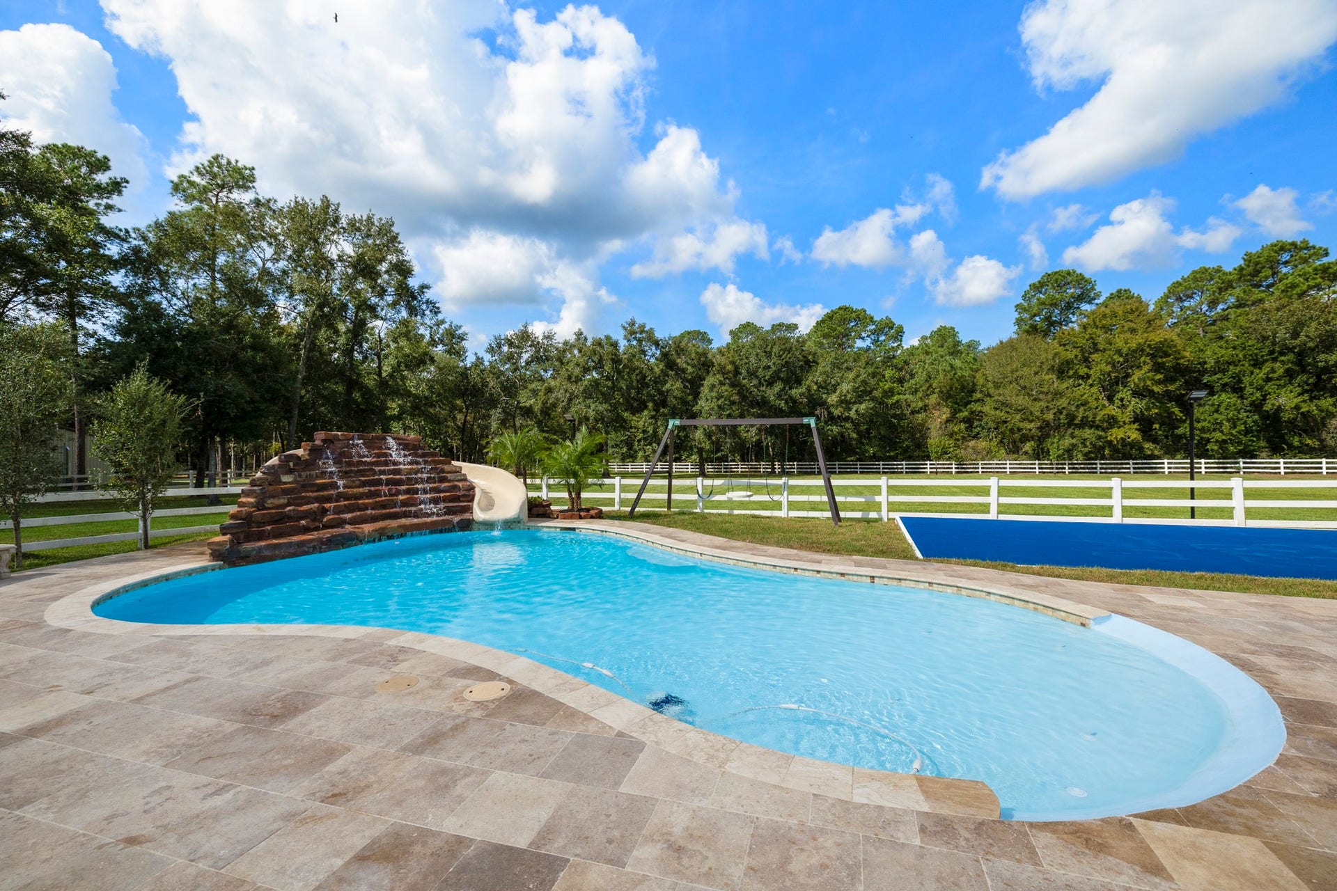 31219 Edgewater Drive, Magnolia, TX 77354 Another view brings the pools stone feature and adjacent sport court into focus.