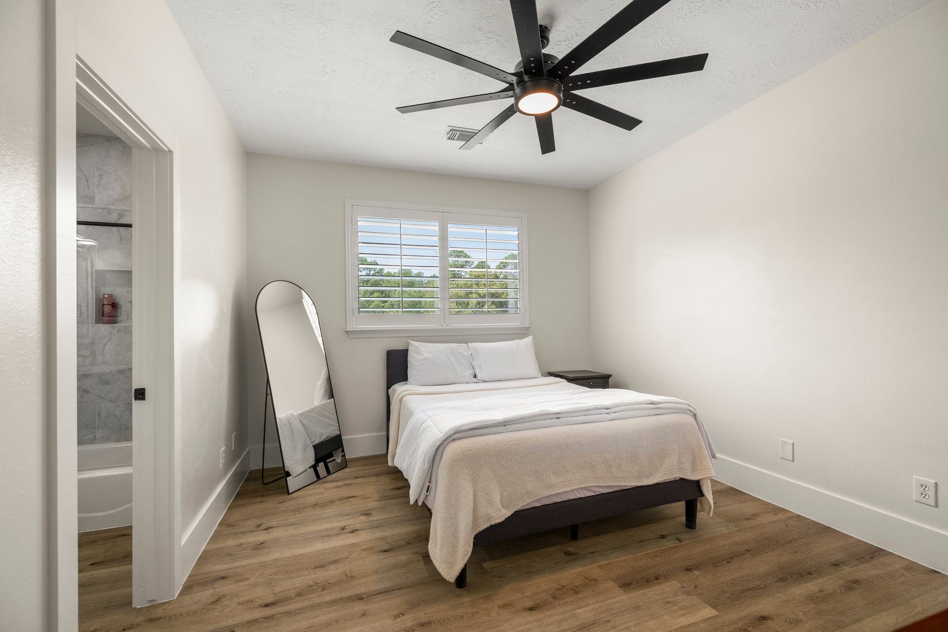 31219 Edgewater Drive, Magnolia, TX 77354 This additional bedroom also features a large ceiling fan and a shuttered window.
