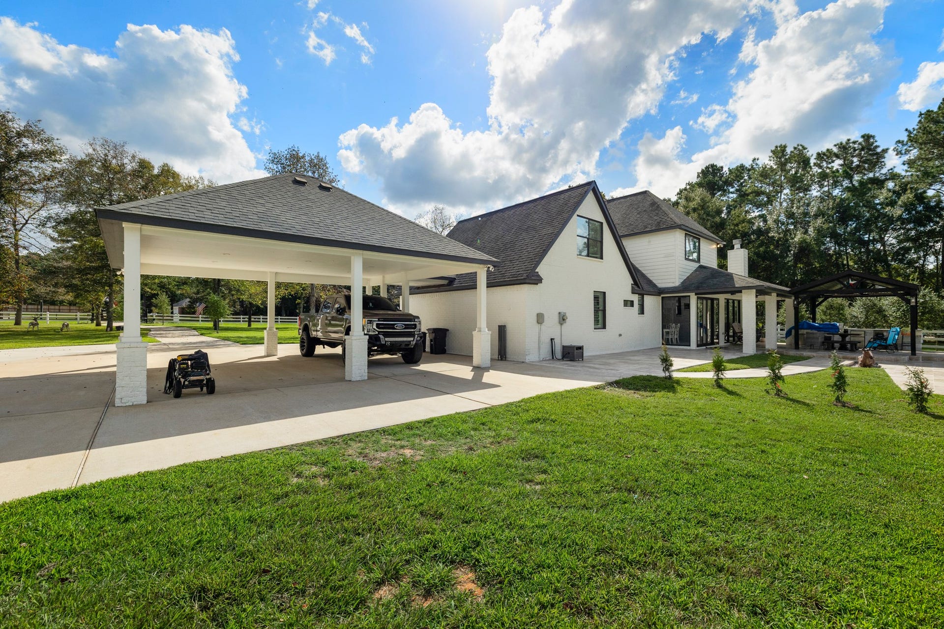 31219 Edgewater Drive, Magnolia, TX 77354 The covered parking area is reached by a wide driveway beside the home.